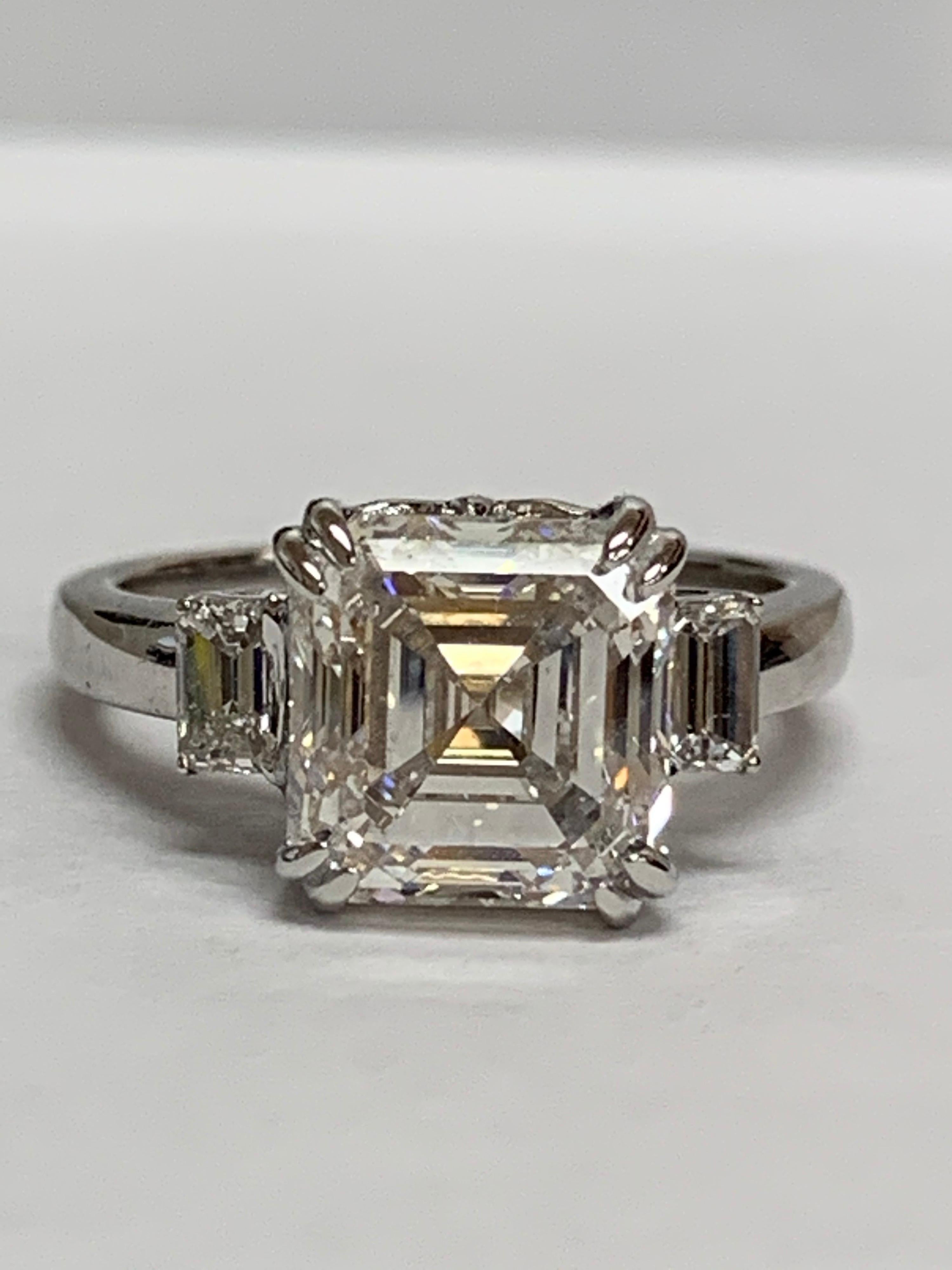 GIA Certified 4.69 Carat  Asscher cut diamond Ring is one of a kind Handcrafted Ring . Natural Diamond is set in 18 Karat white gold with Total diamond weight of  0.37 carat Emerald cut Diamond is elegant Ring . Once you see the ring in your hand