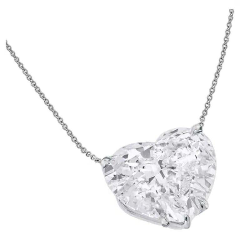 This stunning pendant necklace features a magnificent 4.69 carat heart cut diamond set in platinum.

This diamond, graded E, is the epitome of purity, boasting an absolutely colorless appearance that radiates unmatched brilliance. A refined choice