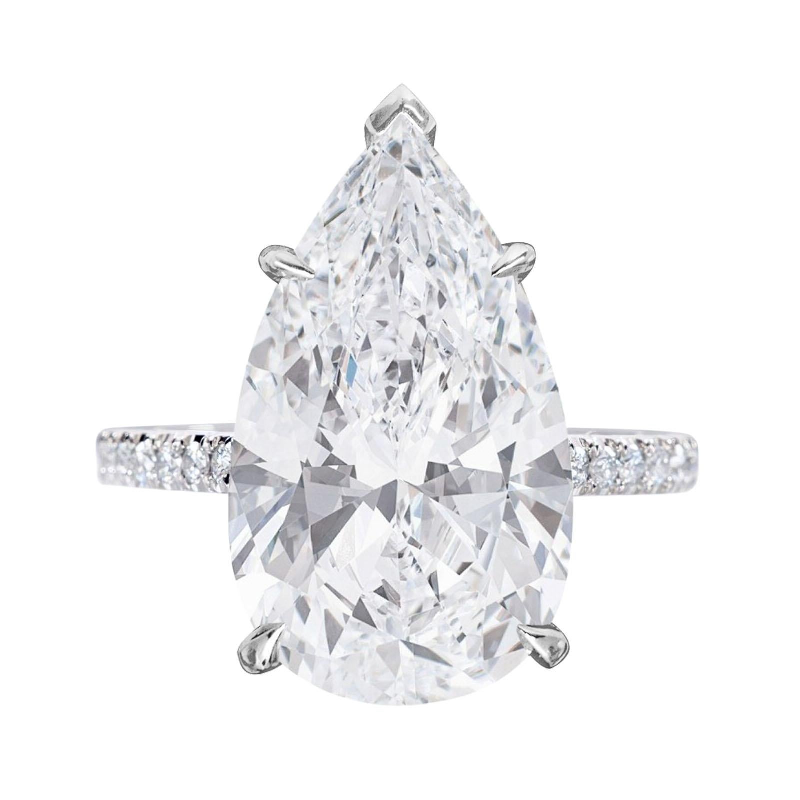 Embrace the epitome of luxury with this GIA Certified 4.71 Carat Pear Cut Diamond Ring adorned with pavé diamonds. At the core of this exquisite ring shines a mesmerizing pear-cut diamond, certified by the esteemed Gemological Institute of America