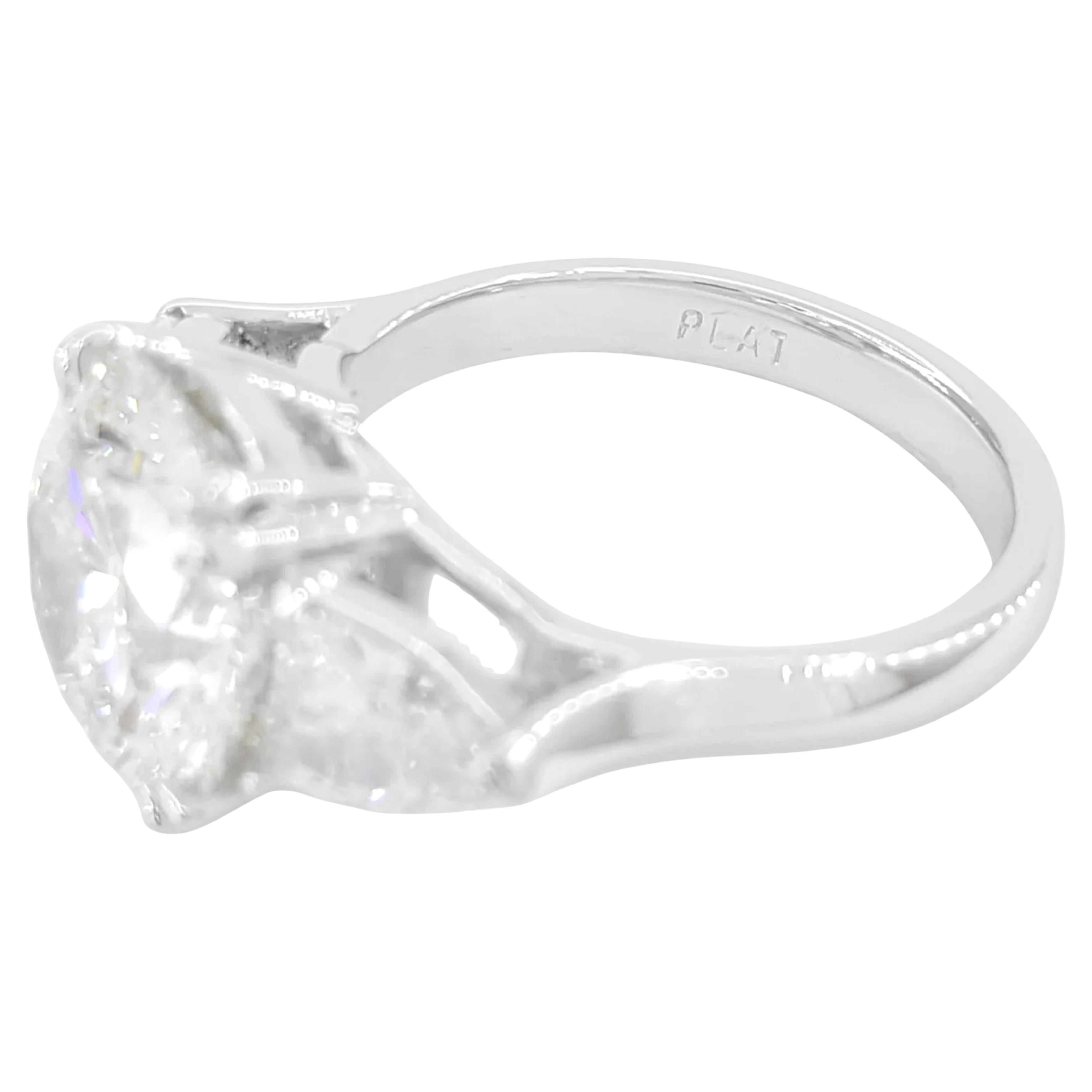  3-Stone Engagement Ring, meticulously crafted in platinum for a timeless look. This stunning ring features a total weight of 5.74 ct, combining a breathtaking center stone and elegant side diamonds. The center stone is a natural 4.71 ct Round