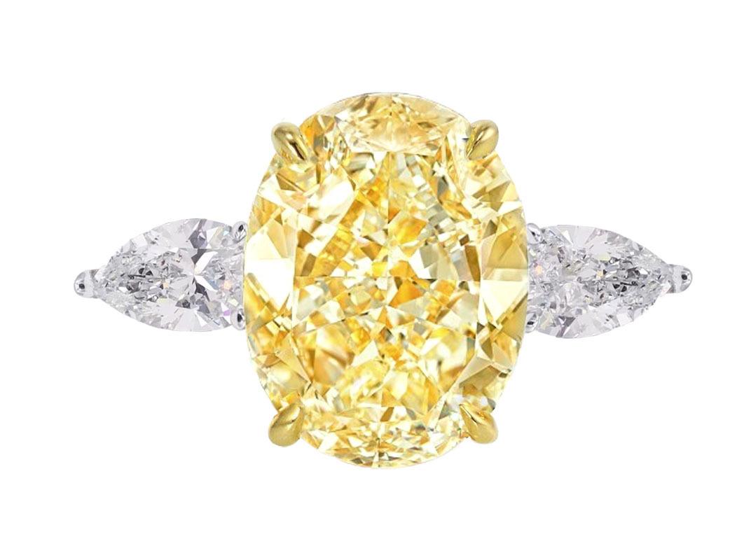 radiant beauty: our exquisite 4.72 carat Natural Oval Brilliant Cut diamond.
This stunning gem features a captivating Fancy Light Yellow hue with an amazing vivid color, exuding warmth and vibrancy that's sure to leave a lasting impression.
With VS2