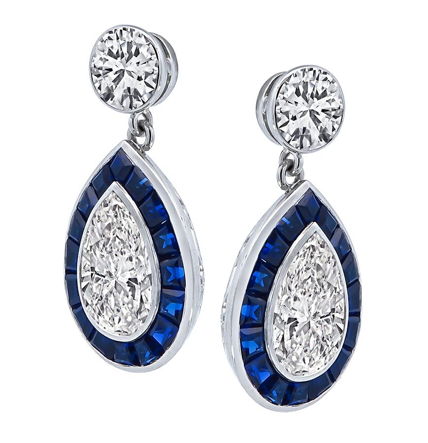 This is a stunning pair of platinum and 14k white gold dangling earrings. The earrings feature sparkling GIA certified round and pear shape diamonds that weigh 0.68ct, 0.67ct, 1.63ct and 1.78ct. The color of the diamonds is I with VS1 clarity, H