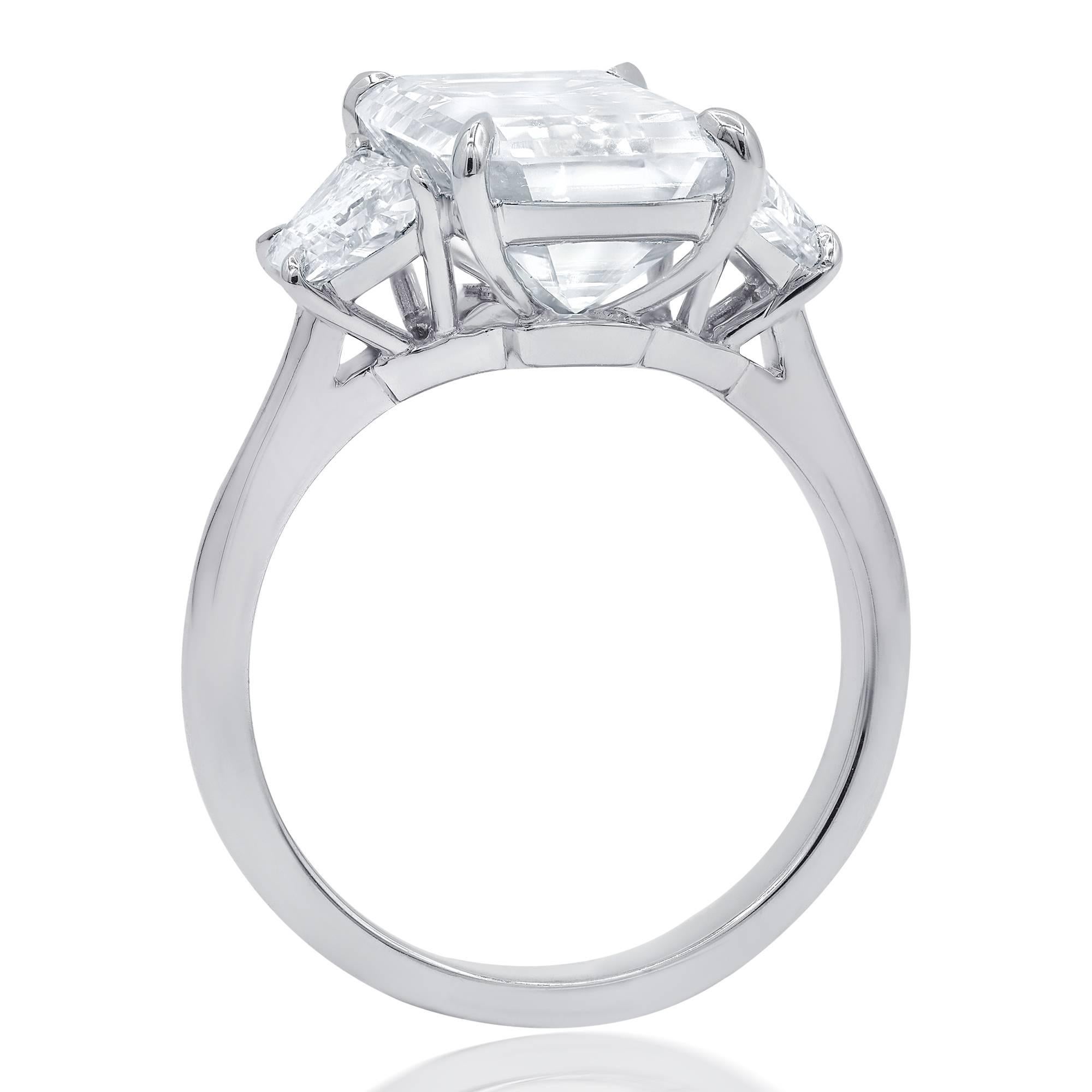 GIA certified diamond engagement ring with emerald cut diamond in the center,weighing 4.83 carat H color and VS1 clarity set in custom made platinum mounting with additional  0.90 carats total of  trapezoid diamonds on each side.