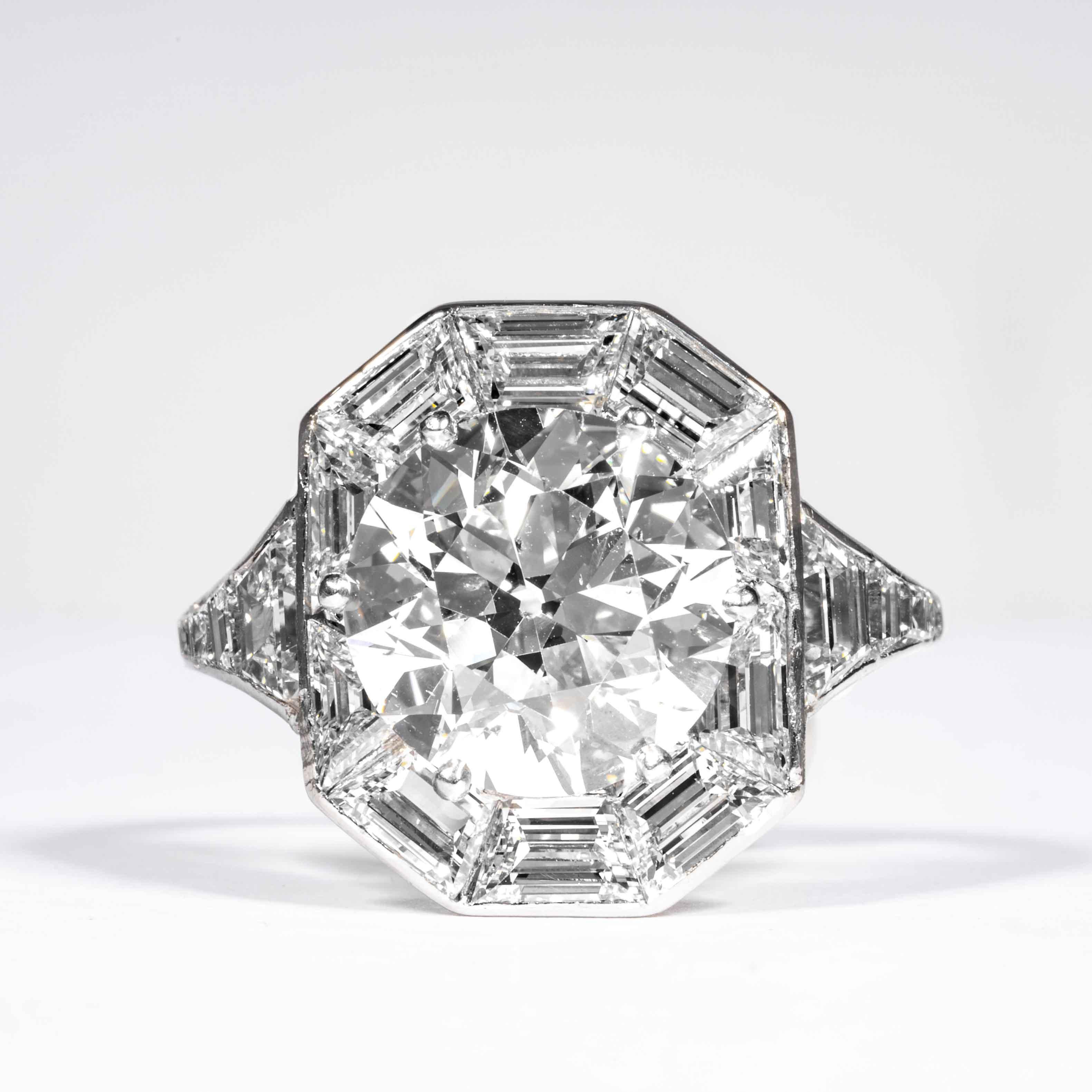 This elegant and classic diamond ring is offered by Shreve, Crump & Low. This 4.92 carat GIA Certified I SI2 old european cut diamond measuring is a unique and enchanting art deco platinum and diamond ring. The 4.92 carat center diamond is accented