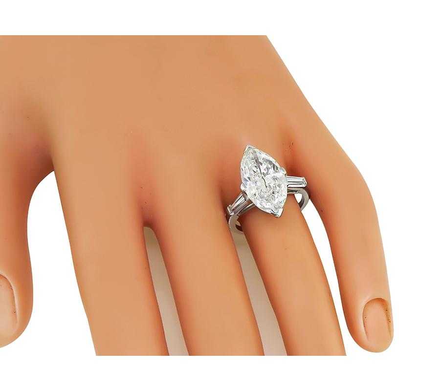 This is a stunning platinum engagement ring. The ring is set with sparkling GIA certified marquise cut diamond that weighs 4.92ct. The color of the diamond is J with I2 clarity. The center diamond is accentuated by dazzling baguette cut diamond