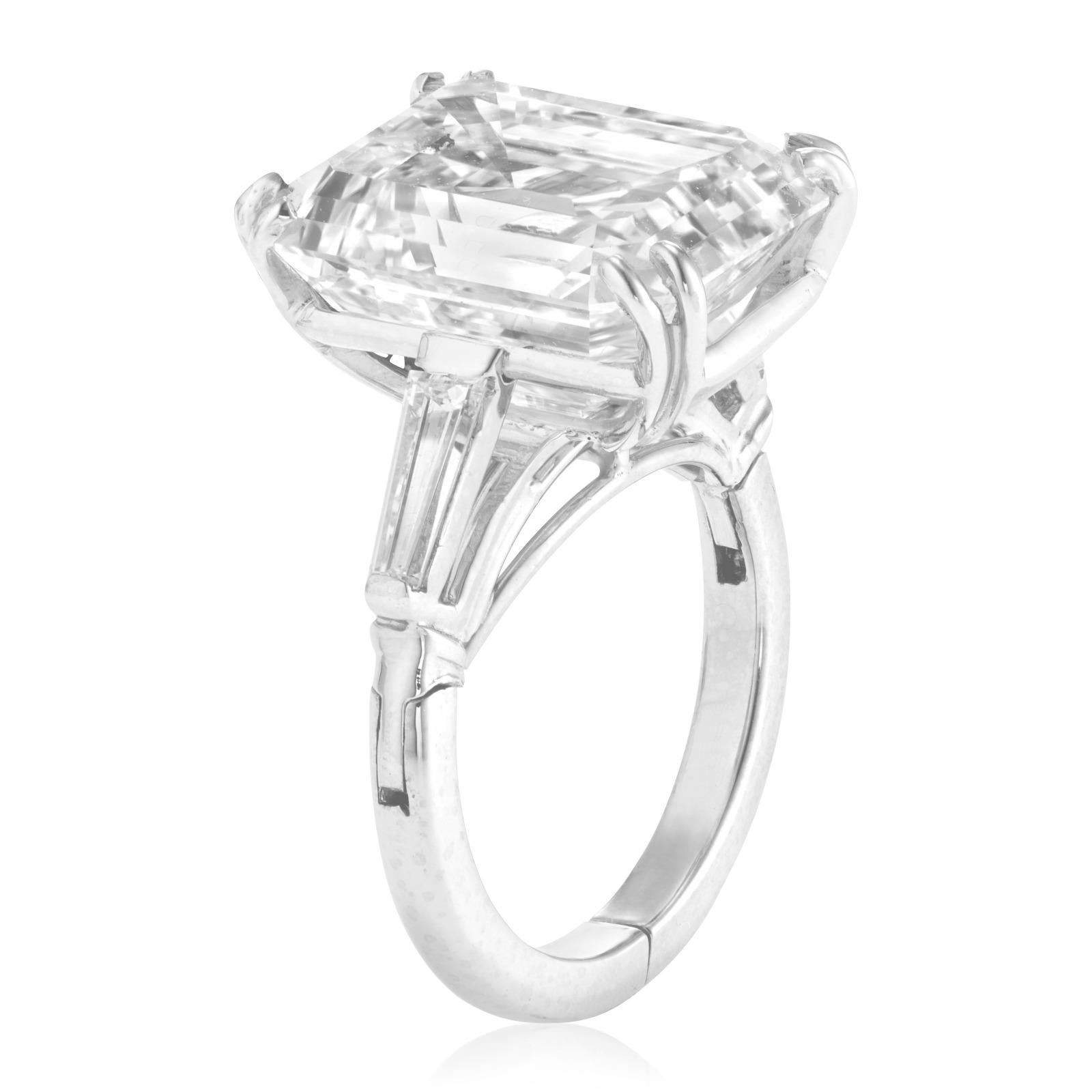 This exquisite ring showcases a stunning 5.40 carat emerald cut diamond, set in luxurious 18K white gold. 

The diamond's exceptional color grade I and clarity grade VS2 highlight it’s radiant brilliance and pure quality. 
Flanked by elegantly