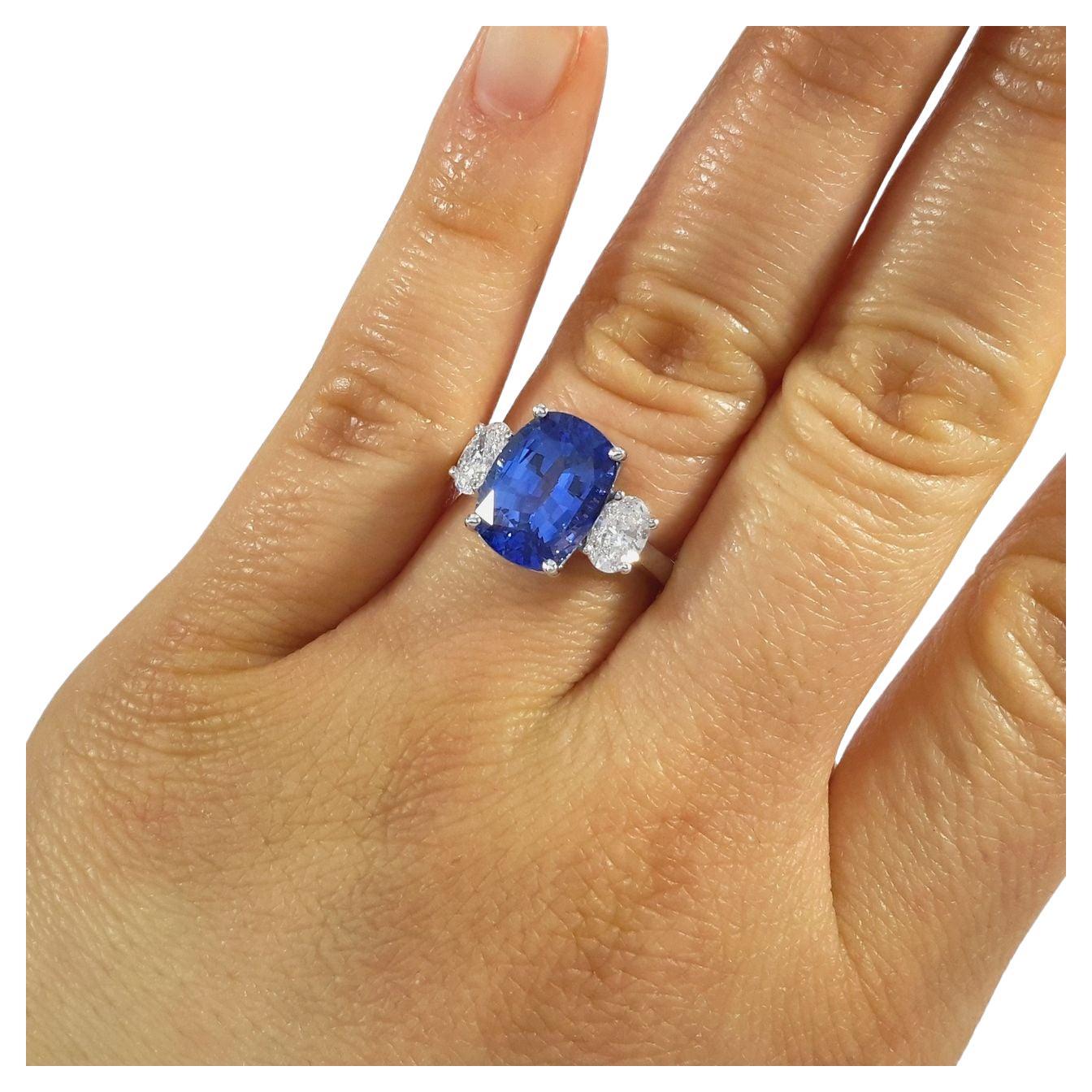 This exquisite 5 carat blue sapphire cushion-cut diamond ring features a stunning center stone that is GIA certified, ensuring its quality and authenticity. The sapphire's intense blue hue is mesmerizing and is further enhanced by its cushion cut,