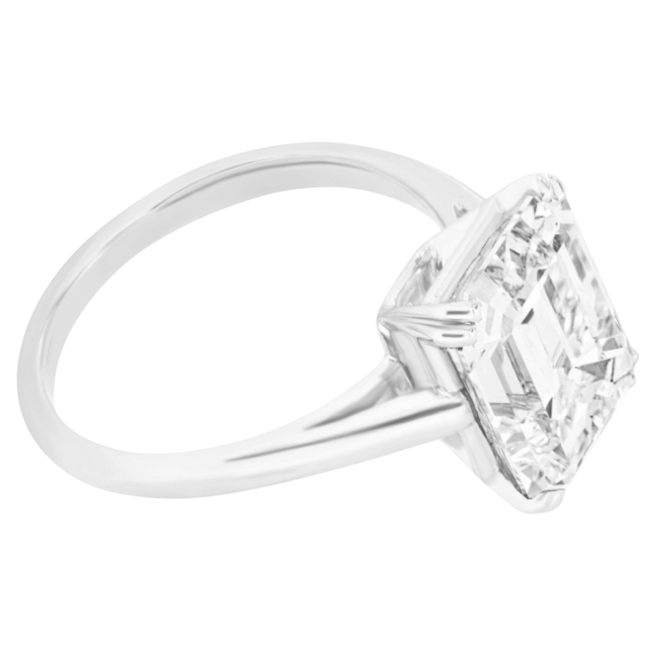 This refined engagement ring features a GIA certified 5.01 carat emerald cut diamond set in sleek platinum for a minimalist and elegant solitaire presentation. The step cut structure of the center stone offers a distinctive hall of mirrors effect,