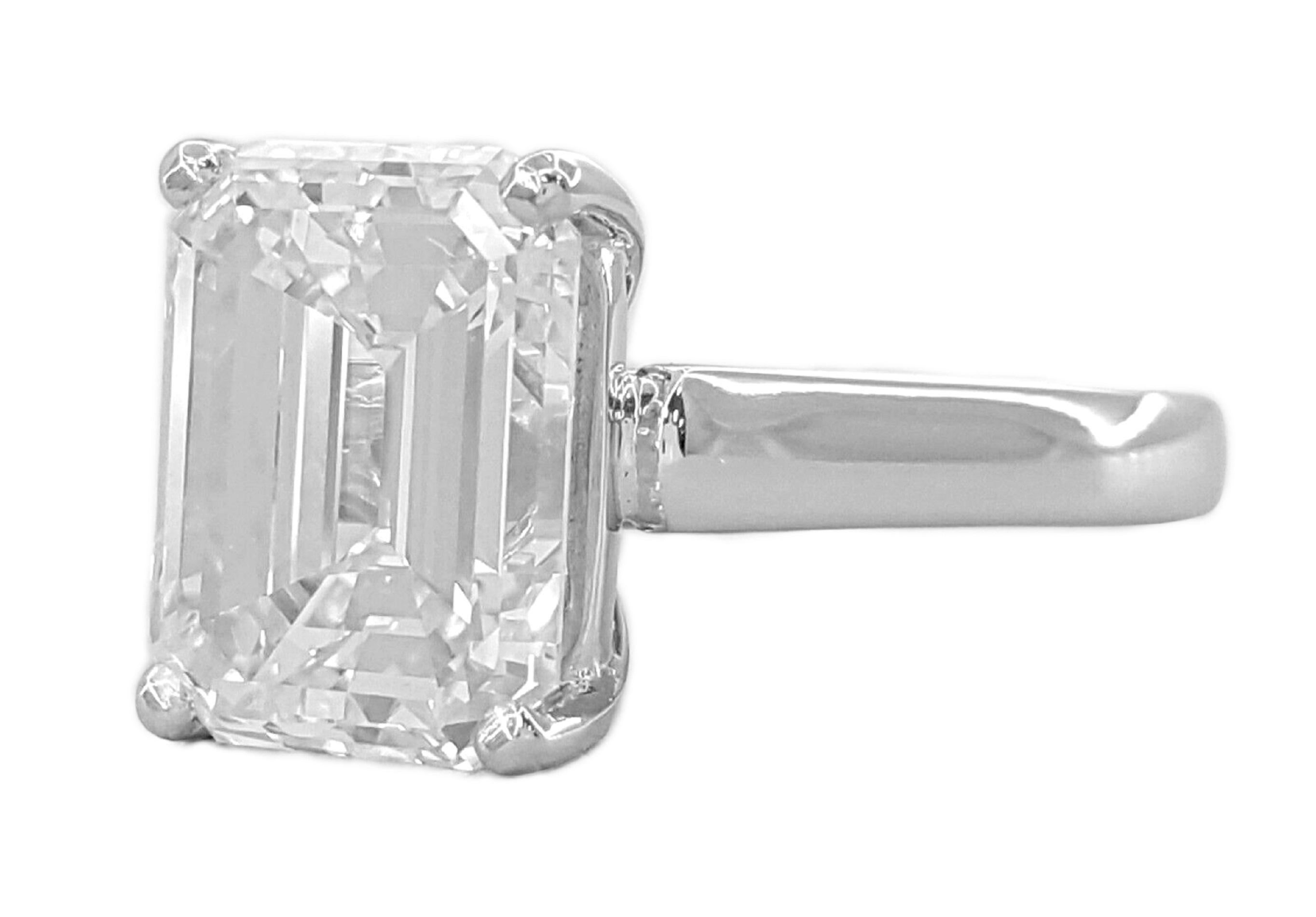 5.03 ct total weight Platinum Emerald Cut Diamond Engagement Ring.

The ring weighs 10.4 grams, size 5, the center stone is a Natural Emerald Cut diamond weighing 5.03 ct, I in color, VS1 in clarity, Very Good Polish, Good Symmetry & None