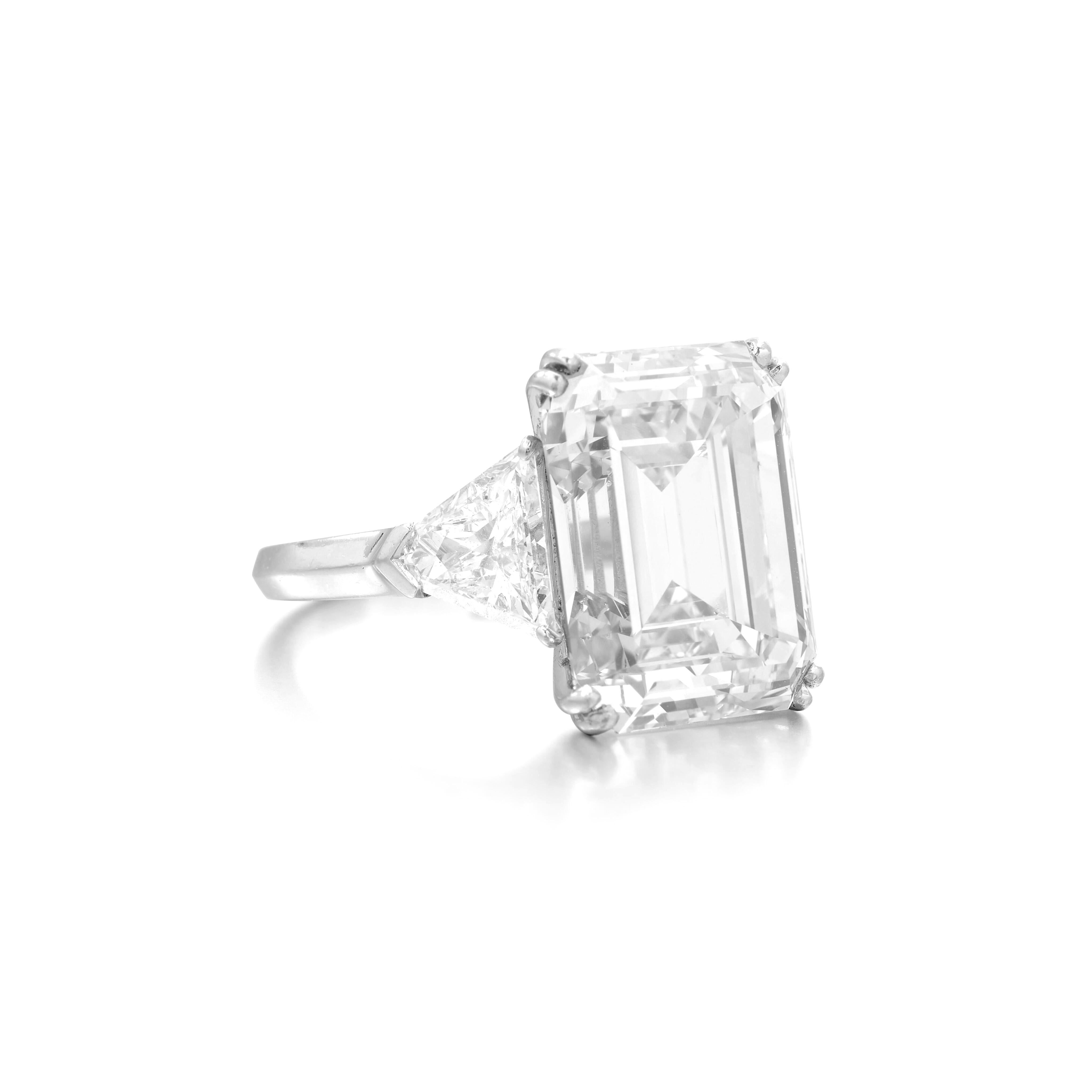 5 carat emerald cut diamond set in luxurious platinum, exuding elegance and sophistication. The central diamond is GIA certified, ensuring its quality and authenticity, with a F color and vvs2 clarity that contribute to its remarkable brilliance and