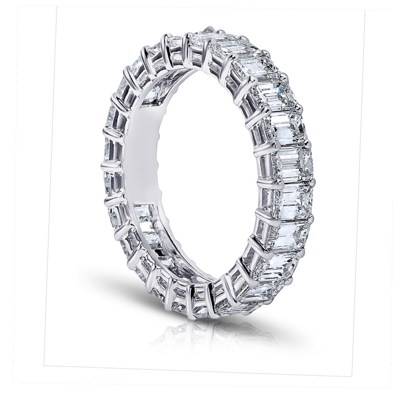 Emerald Cut diamond ring platinum eternity band shared prong style with a gallery.
21 perfectly matched diamonds weighing a minimum of 4.75 cts. G.I.A certificates for each diamond . Ranging from D-F in color . VVS1-VS2 in clarity .Finger size 5.