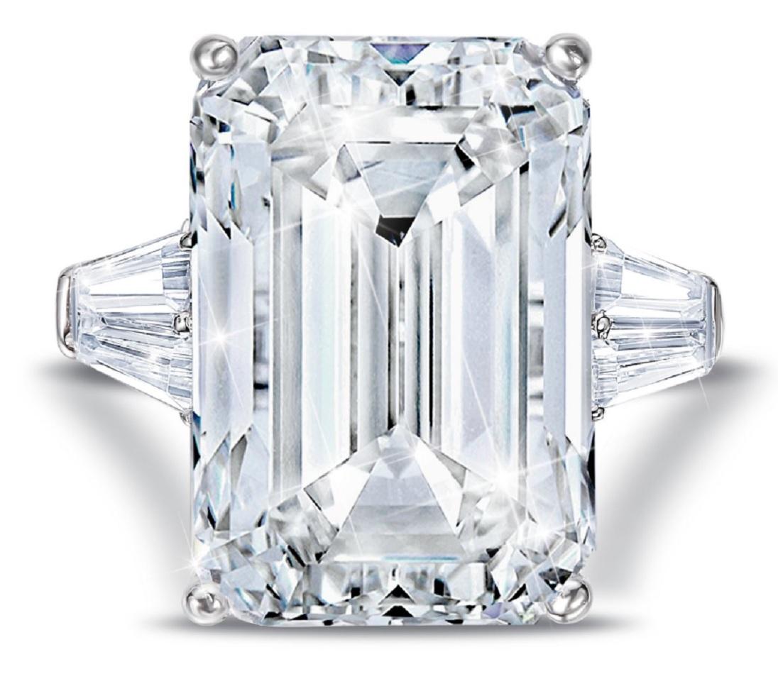 This exquisite ring  features a GIA Certified 5 carat Emerald cut diamond of K color and SI1 Clarity 100% Eye clean. Flanked by a pair of tapered baguettes = approximately 0.50 ctw set in a platinum mounting, this ring will forever remain a classic