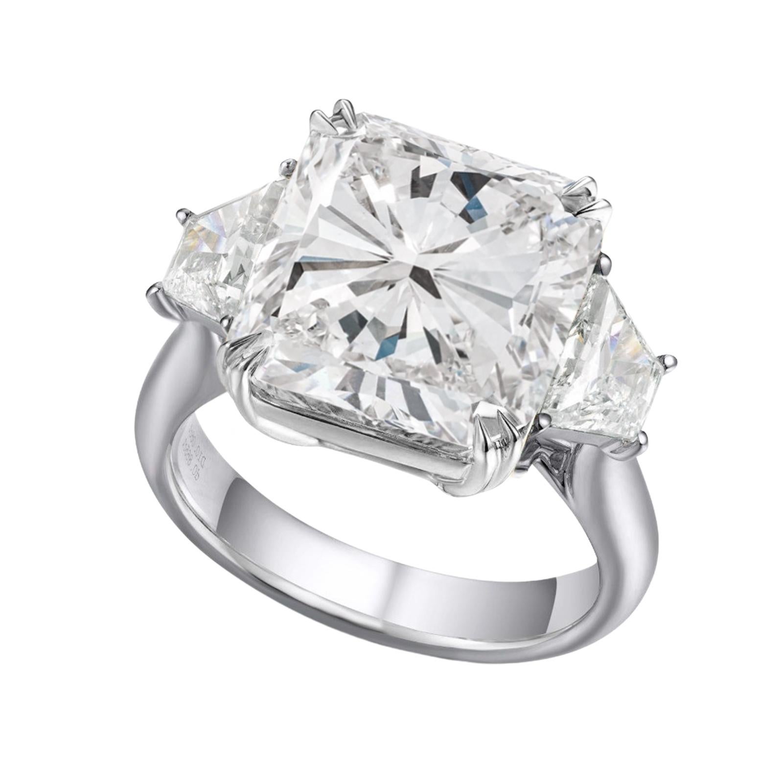 Introducing a truly mesmerizing centerpiece in the realm of luxury—our exceptional brilliant cushion diamond, adorned by the company of two sleek tapered baguette diamonds. This radiant ensemble is elegantly cradled in a setting of solid platinum,