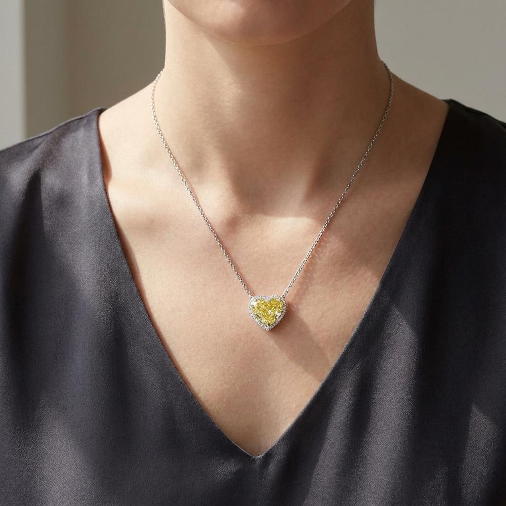 This exquisite pendant necklace features a breathtaking 5-carat heart-shaped modified brilliant diamond, GIA certified, in a captivating natural fancy intense yellow hue. The diamond boasts an impressive VS2 clarity grade, ensuring exceptional