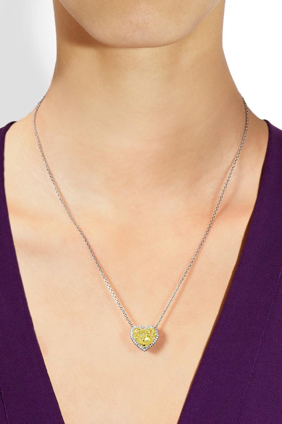 This exquisite pendant necklace features a breathtaking 5.02-carat heart-shaped modified brilliant diamond, GIA certified, in a captivating natural fancy yellow hue. The diamond boasts an impressive VVS2 clarity grade, ensuring exceptional purity