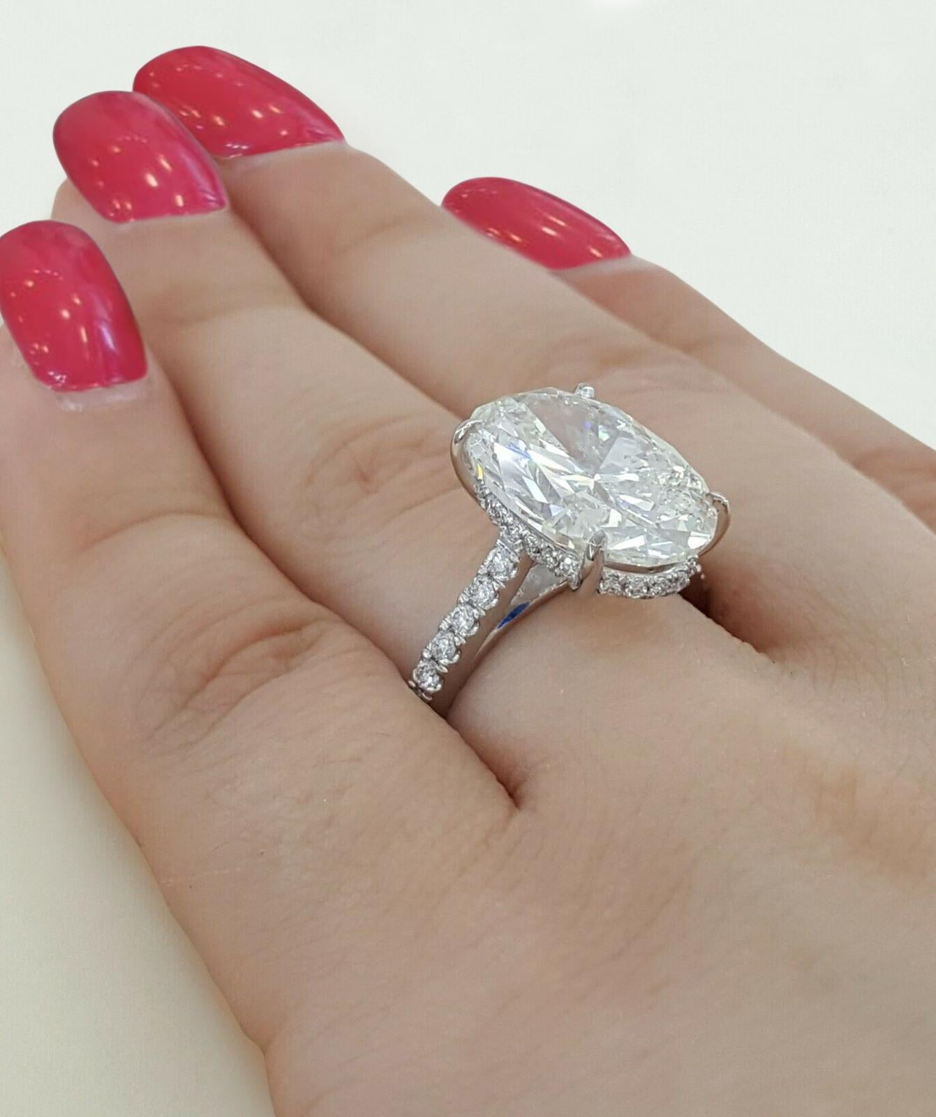 This stunning engagement ring features a 5.02 carat oval-cut diamond as its centerpiece, offering timeless beauty and exceptional brilliance. 

Certified by GIA, the diamond is graded I in color, showcasing a bright and nearly colorless appearance.
