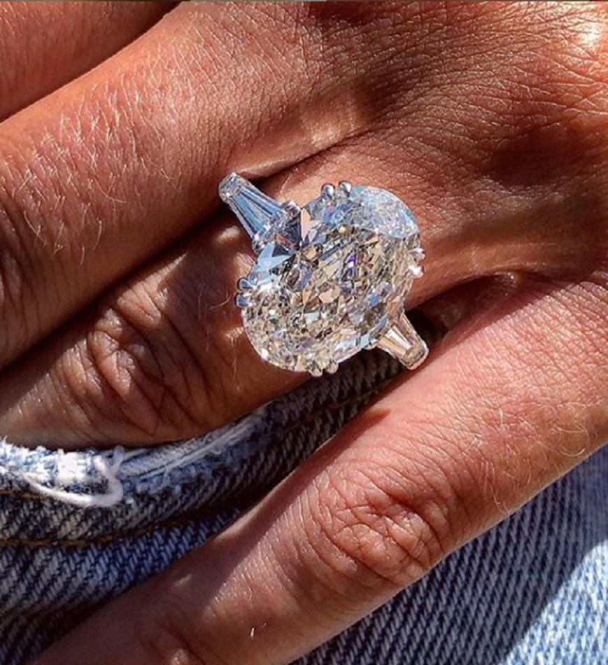 Contemporary GIA Certified 5.01 Carat Oval Diamond with Tapered Baguette in 18K White Gold For Sale