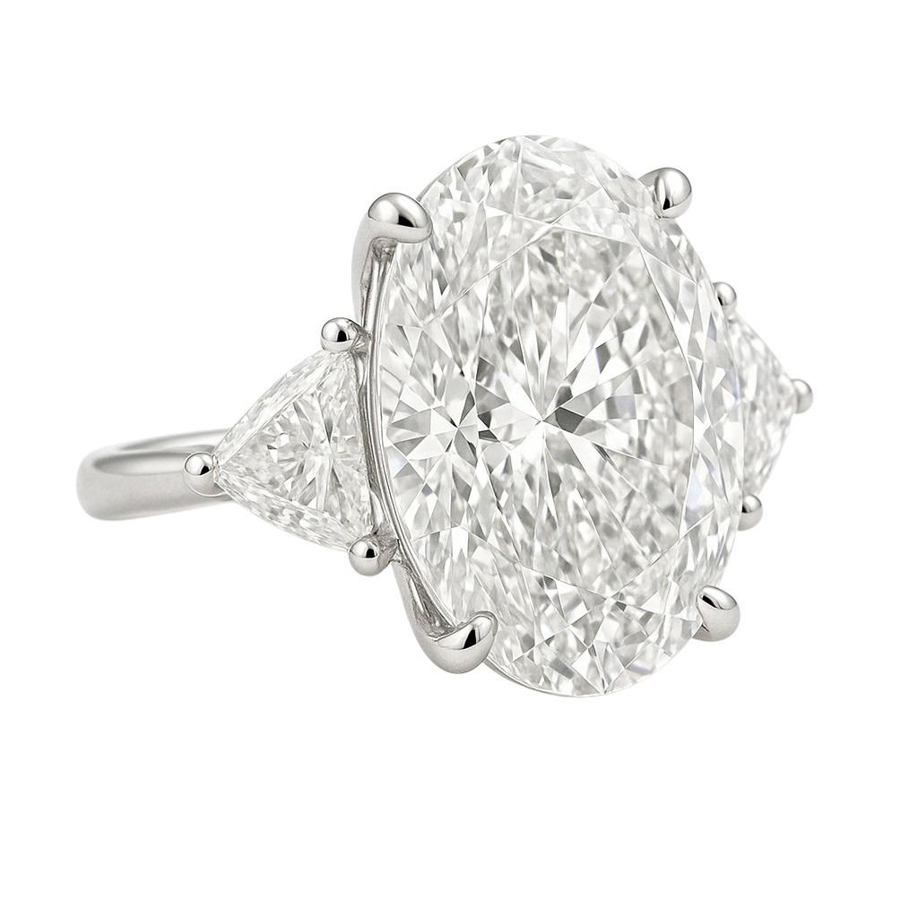 Elegant and timeless, this exceptional ring is crafted in platinum and features a spectacular 5.01 carat oval brilliant cut diamond at the center, graded F color, Internally Flawless by GIA. 

The center stone is flanked by a pair of perfectly