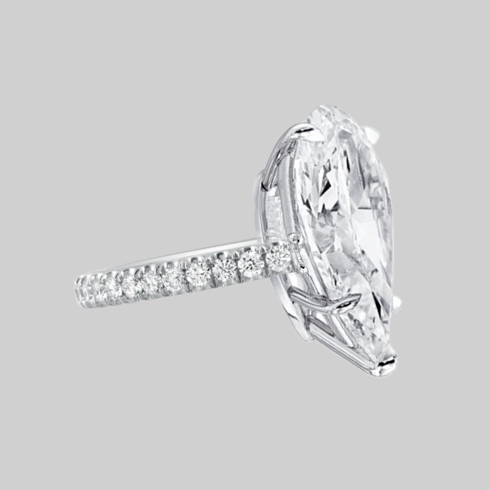 This exquisite ring, featuring a GIA-certified pear-shaped diamond, is a perfect blend of elegance and modern design.

**Center Diamond:**  
The centerpiece of this sophisticated ring is a stunning 5-carat pear-shaped diamond, a testament to