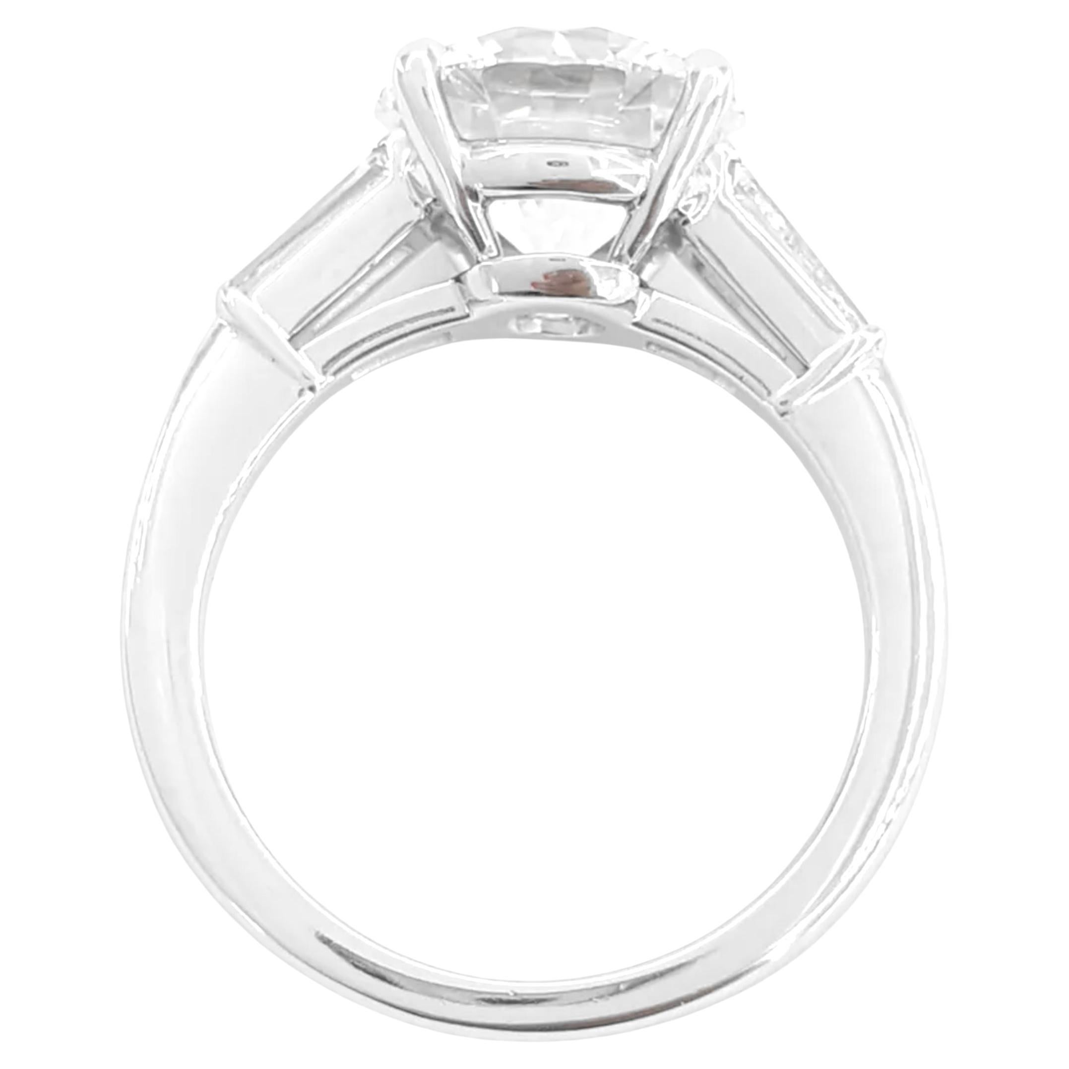 This extraordinary ring features a magnificent 5 carat round-cut diamond, certified by the GIA. Set in a luxurious platinum mounting, the diamond boasts an F color grade, ensuring a near-colorless appearance that enhances its exceptional clarity and