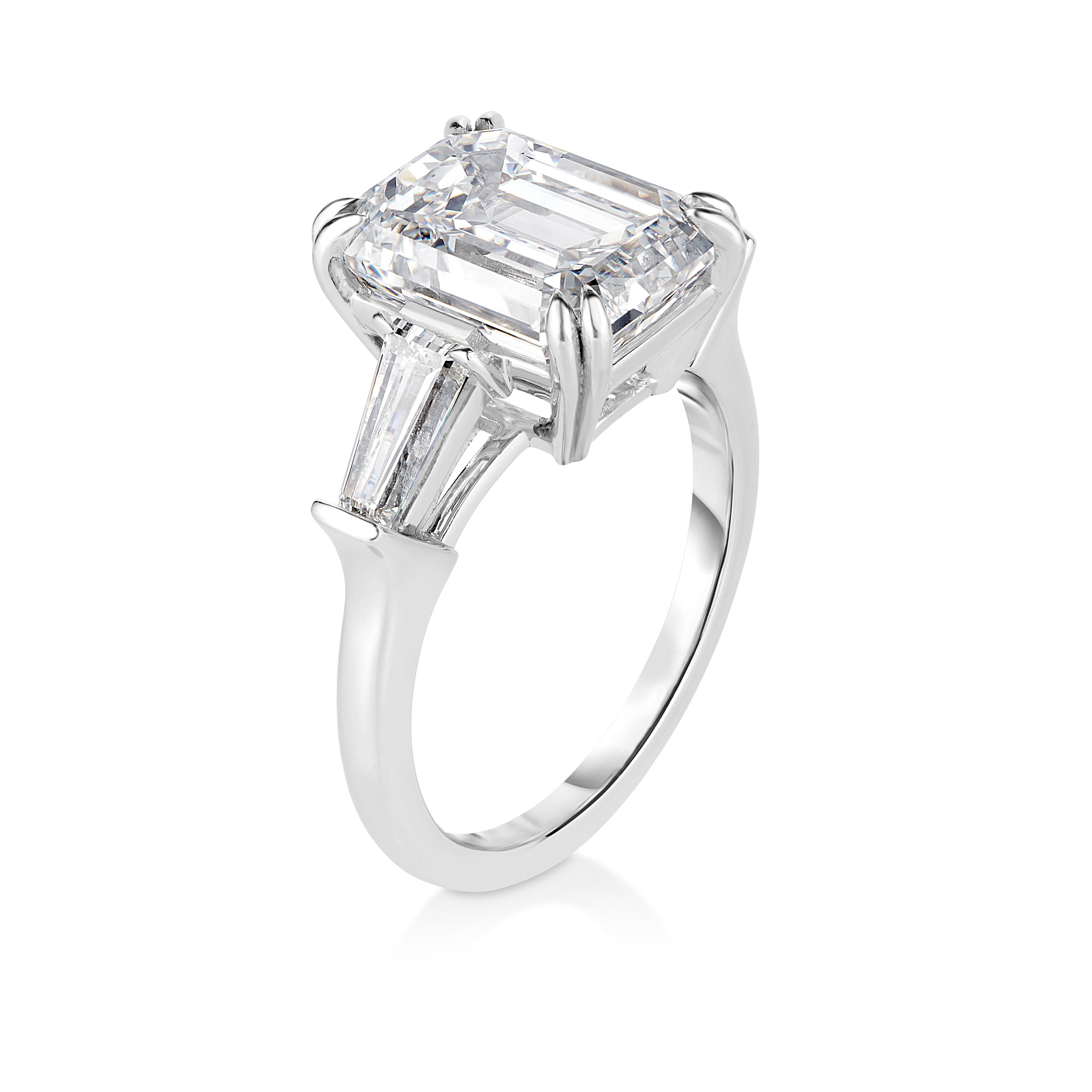 This exquisite 5 carat total weight engagement ring is crafted to captivate hearts and transcend generations, this magnificent piece features a breathtaking center stone—a 4.32 carat GIA Certified Emerald Cut diamond, I Color VVS2 Clarity and