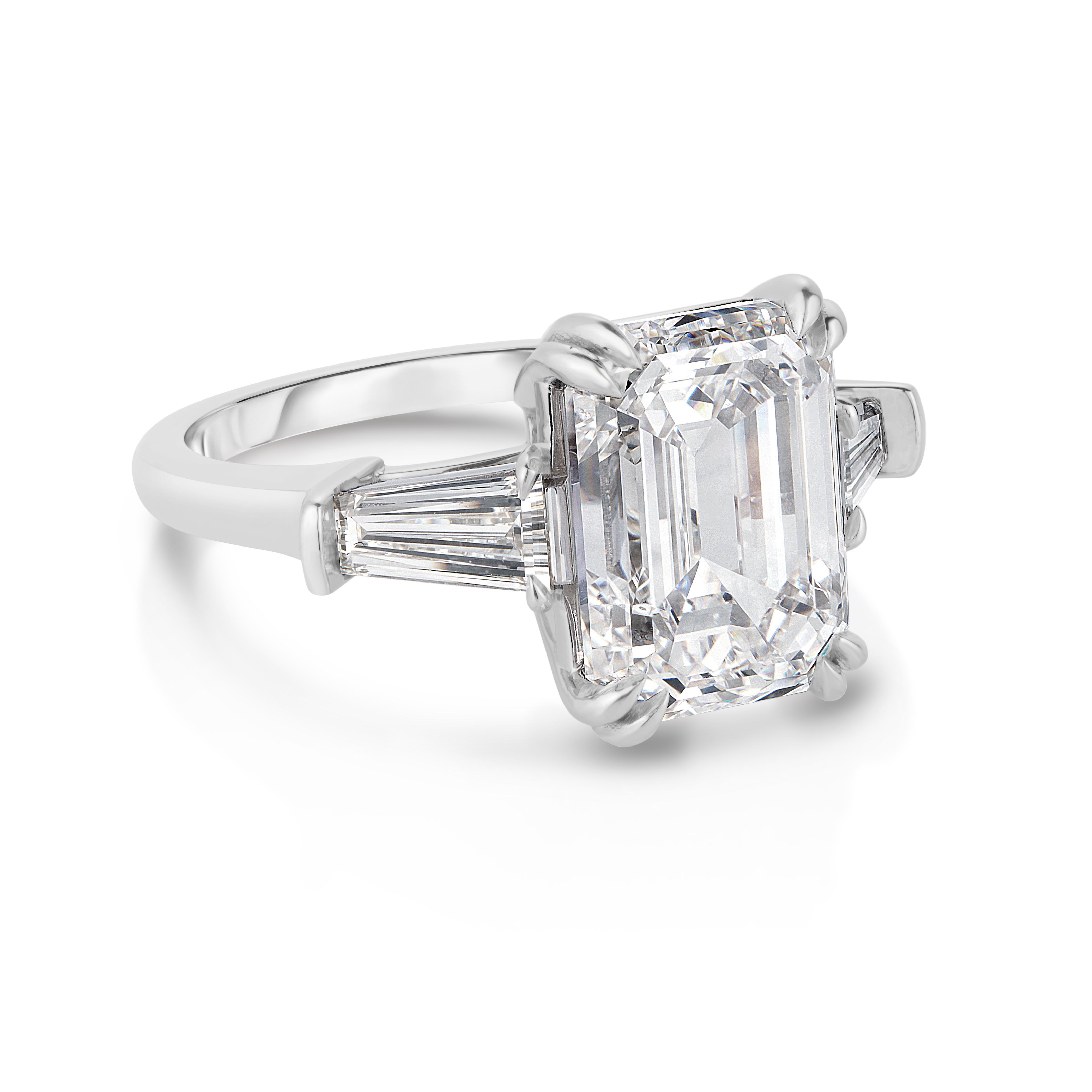 Modern GIA Certified 5 Carat TW Emerald Cut Diamond Three Stone Platinum Ring For Sale