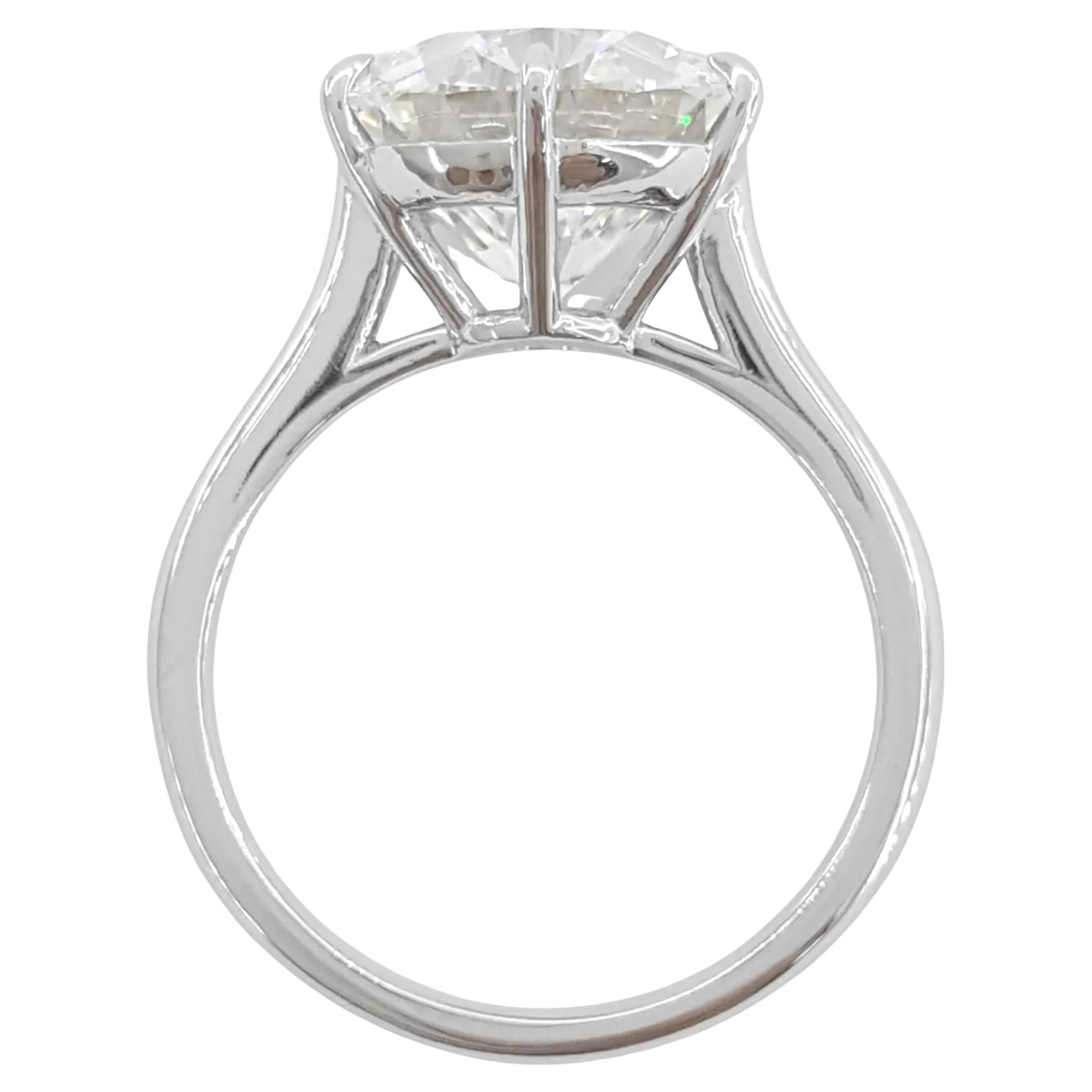  breathtaking 5 ct Round Brilliant Cut Diamond Platinum Solitaire Engagement Ring that embodies elegance and sophistication. This stunning ring weighs 6.2 grams and is sized at 6, featuring a magnificent natural Round Brilliant Cut diamond at its