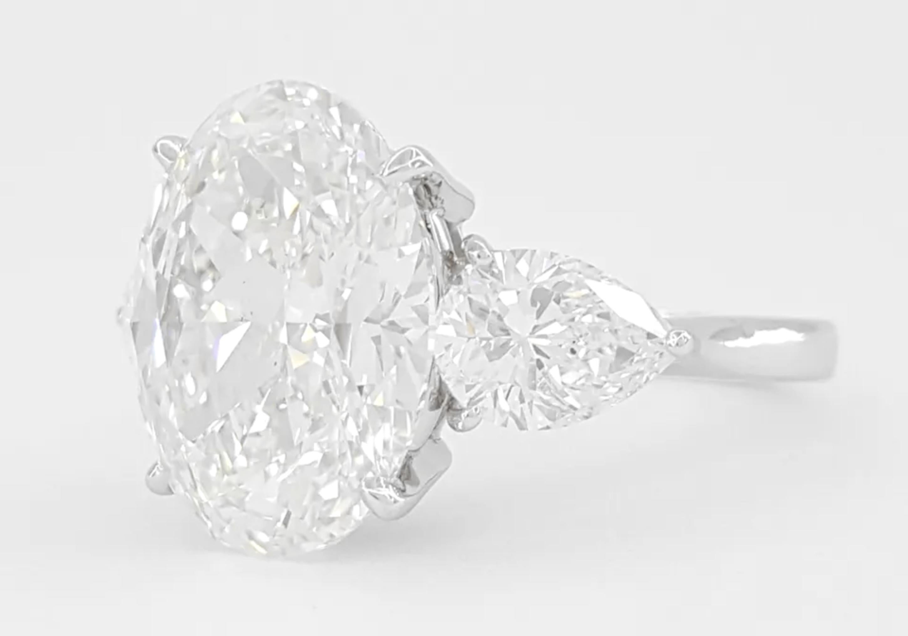 6.55 ct Total Weight Oval Brilliant & Pear Shaped Diamond Three-Stone Engagement Ring in Platinum

Discover unparalleled luxury with this magnificent three-stone engagement ring, featuring a striking 6.55 ct total weight in diamonds. Expertly
