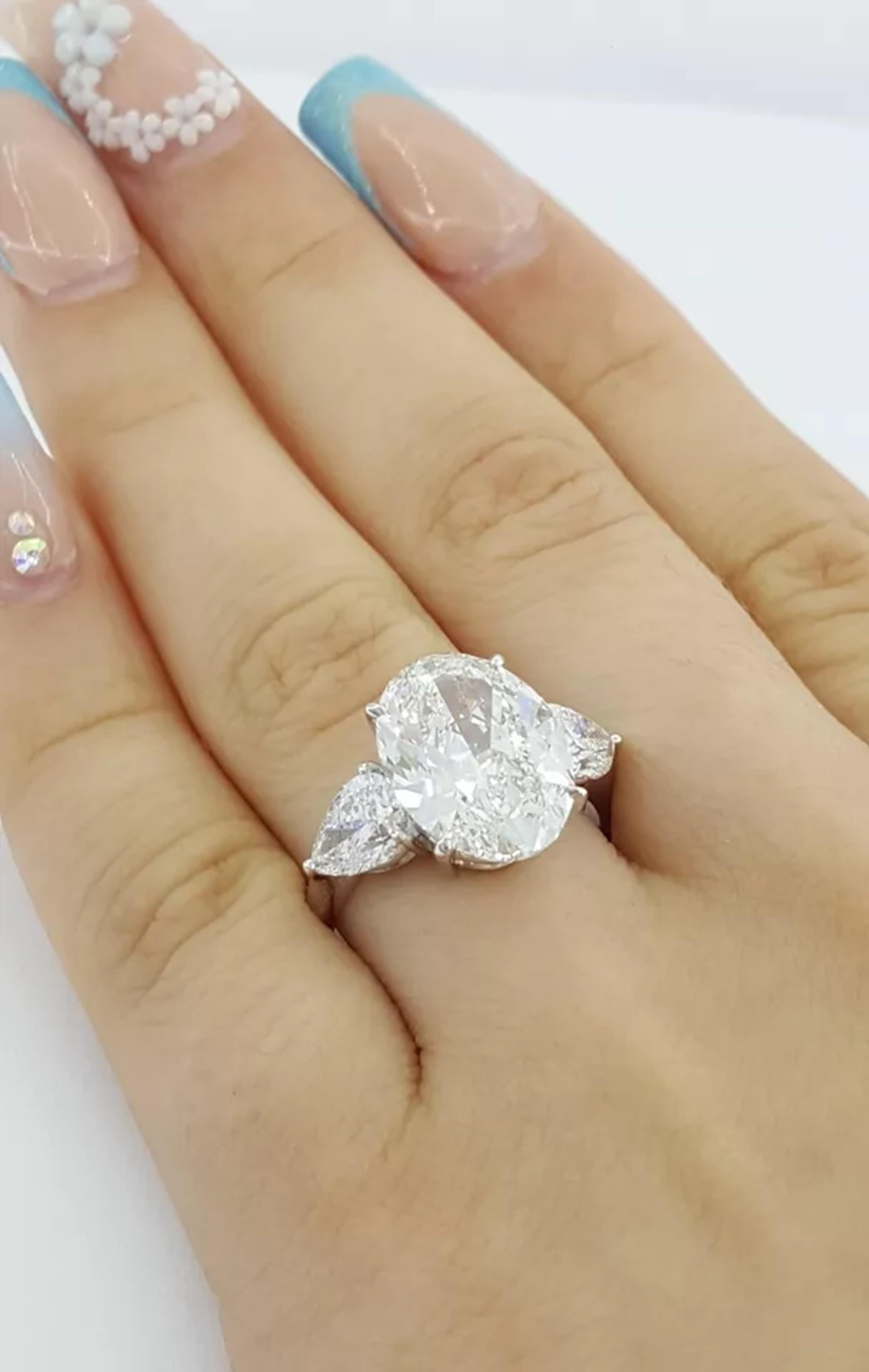 Contemporary GIA Certified 5 ct Total Weight Oval Brilliant & Pear Shaped Diamond Ring For Sale
