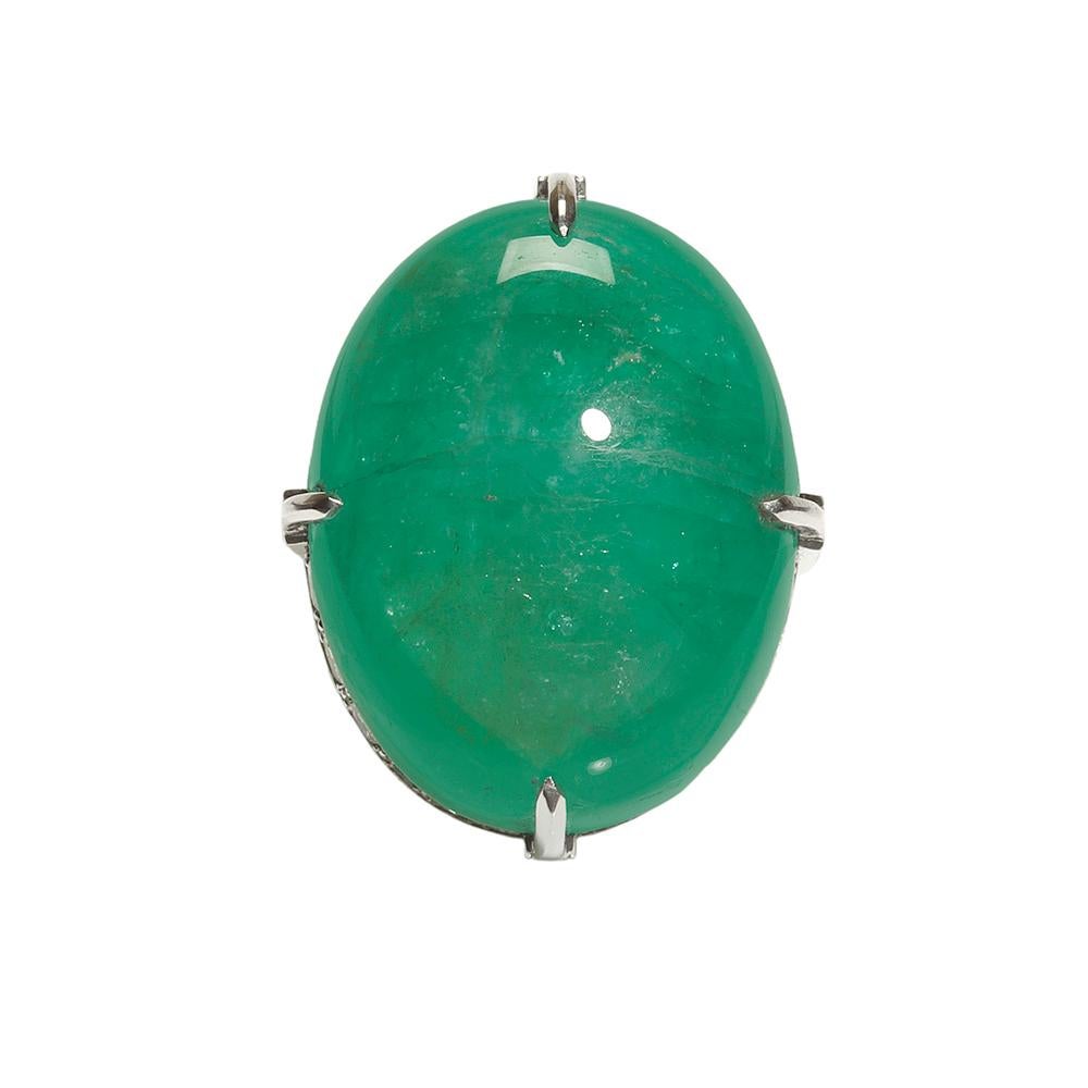 An extremely rare 50 carat Colombian Muso Mine cabochon cut Emerald set a top Brilliant Ideal cut Diamonds in platinum encased with dramatically styled claws. The overall simplicity in design accentuates the uniqueness and importance of this