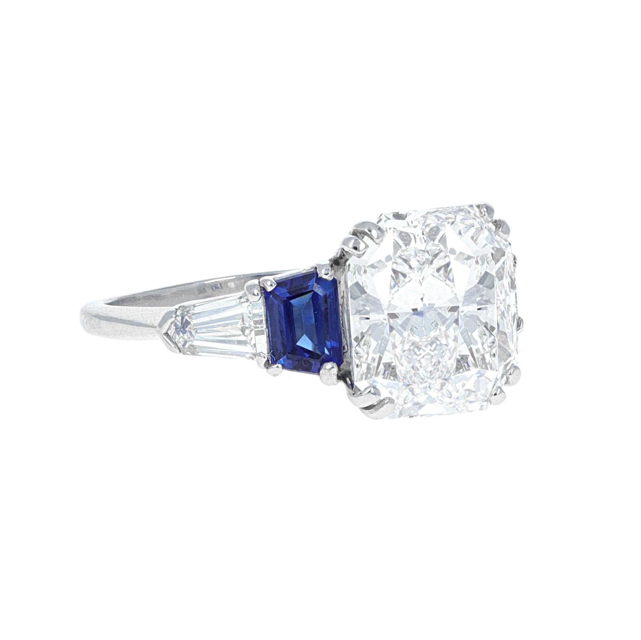 GIA Certified, beautifully made platinum 5.00 carat radiant cut diamond and sapphire ring. The center stone is certified by the Gemoligival Institute of America, GIA. The report states that the center diamond weighs 5.00 carats and is a cut cornered
