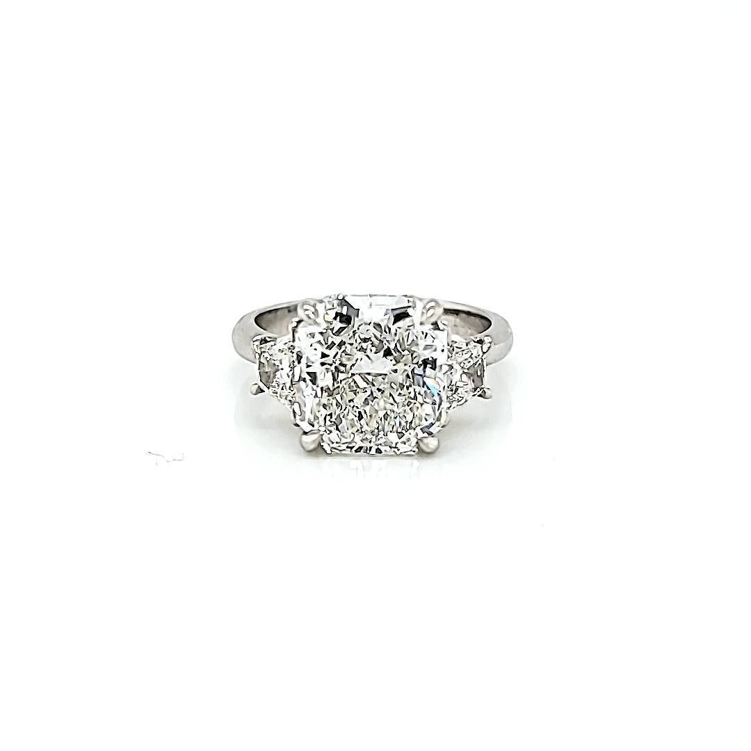 Center stone is a GIA certified 5.00 Carat Radiant cut Diamond. Diamond is H color and VS1 Clarity. Set in a hand made platinum setting with 2 Brilliant Cut Trapezoid Diamonds weighing 0.62 carats total. The side stones are of similar color and