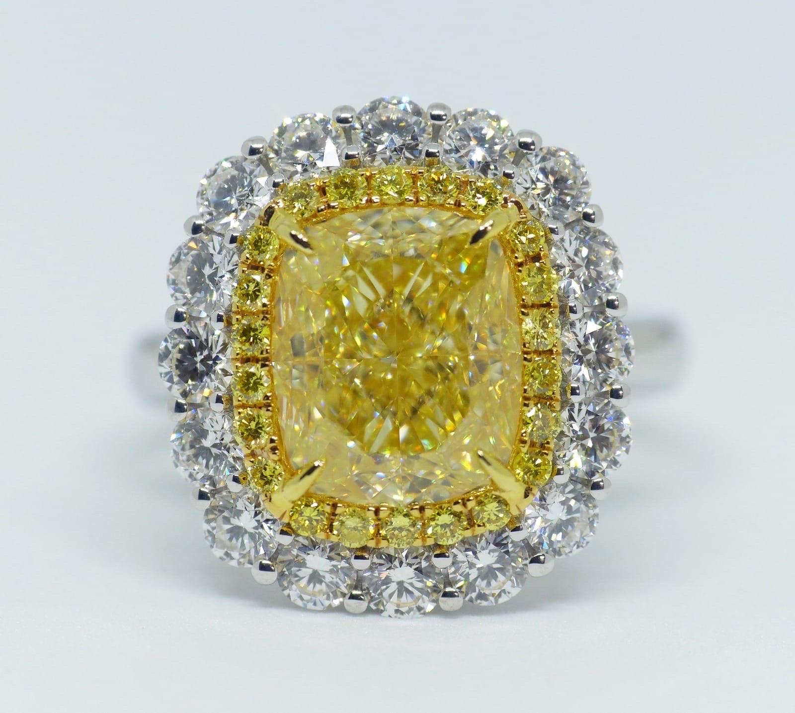 An eye-catching 5.01 carat cushion shaped Fancy Yellow. The exceptional pave work compliments the centre stone. The mounting features a split cathedral shank and a double halo around the centre stone.
VS1 quality GIA certified Diamond surrounded by