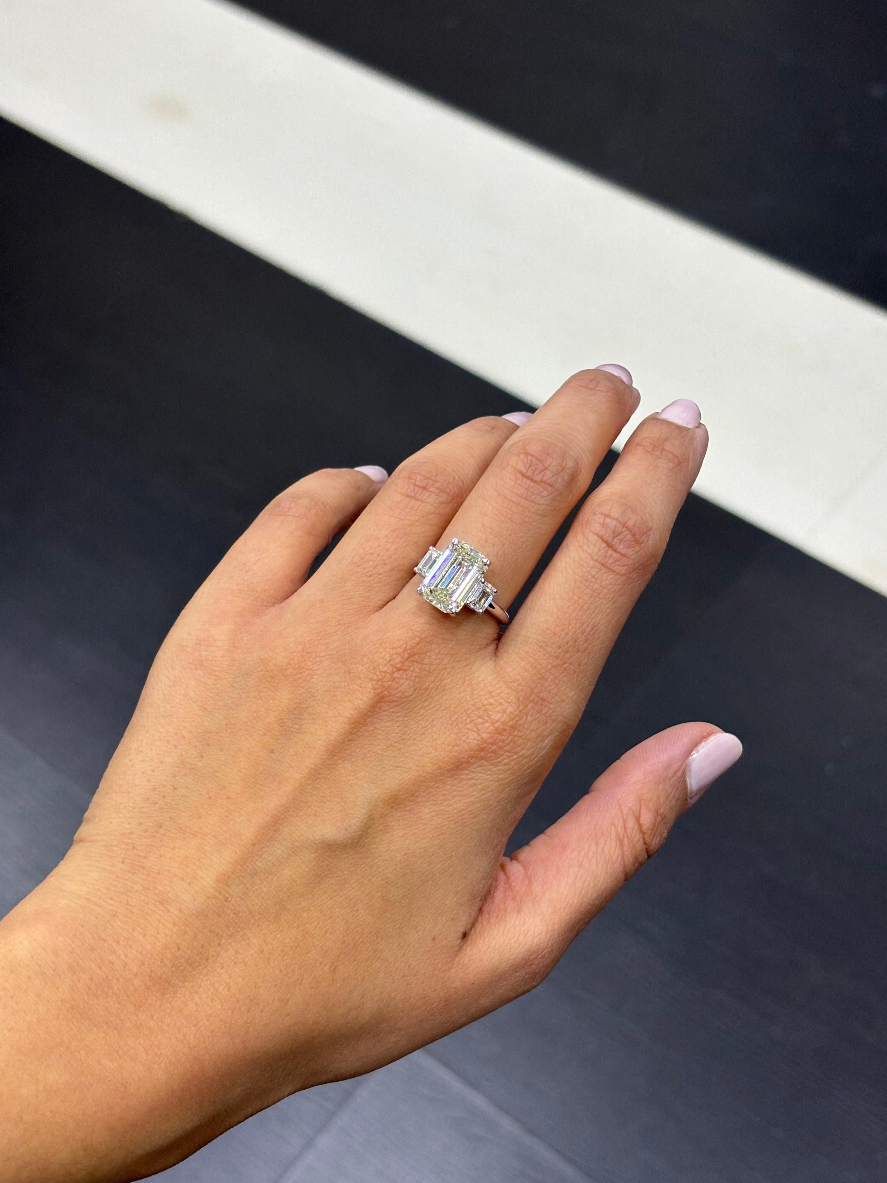 A classic 5.02 carat, GIA certified emerald cut Diamond three stone engagement ring, with 2 0.51 carat each emerald cut side stones VS1/VS2 clarity, H-I color. 
The center stone is GIA certified, N color, SI2 clarity. Set in solid 18K White Gold,