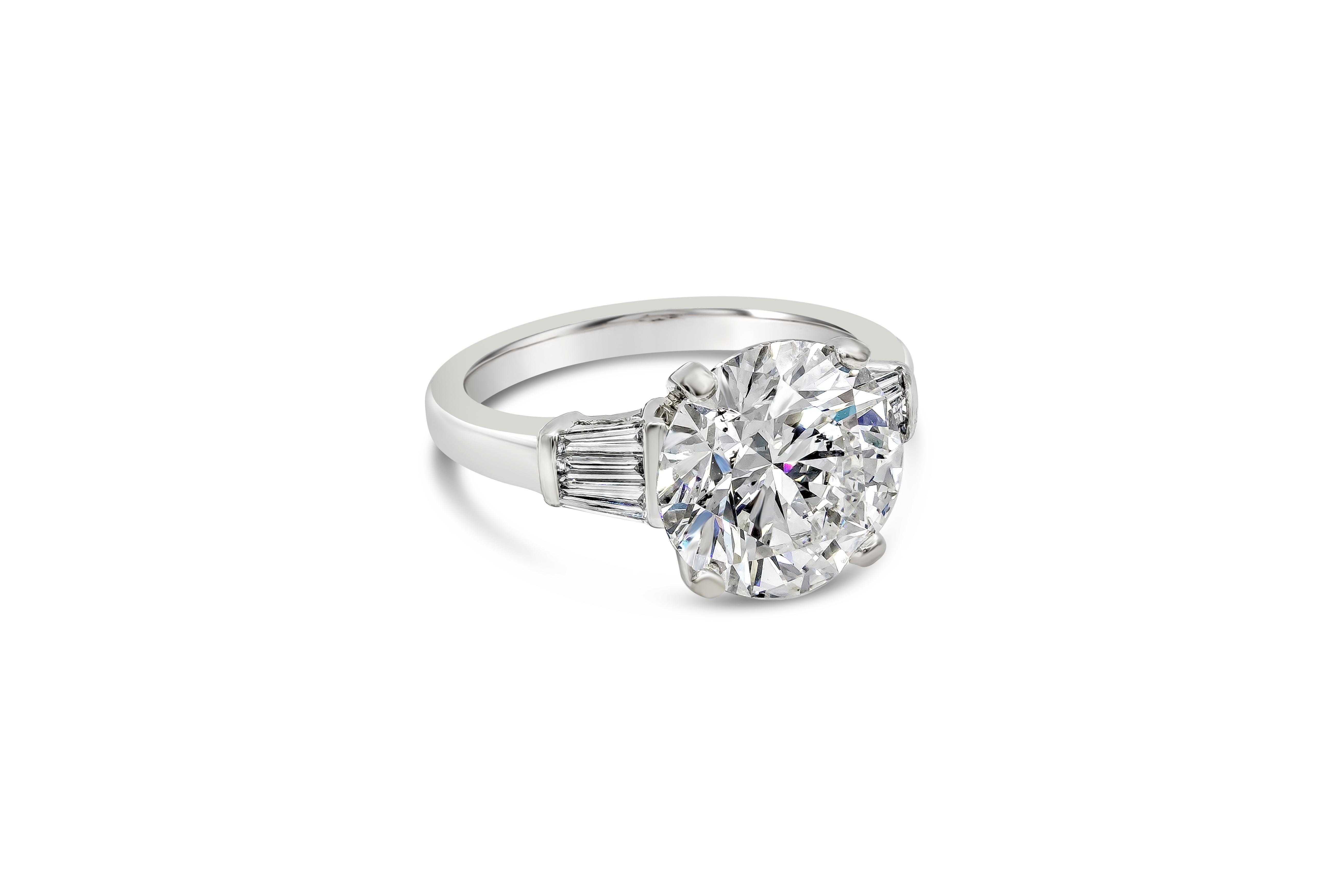 A classic and unique engagement ring style showcasing 5.02 carat brilliant round diamond certified by GIA as G color, SI2 in clarity. Accenting by weighing 0.37 carat total three tapered baguette diamonds on either side, to make it look like one