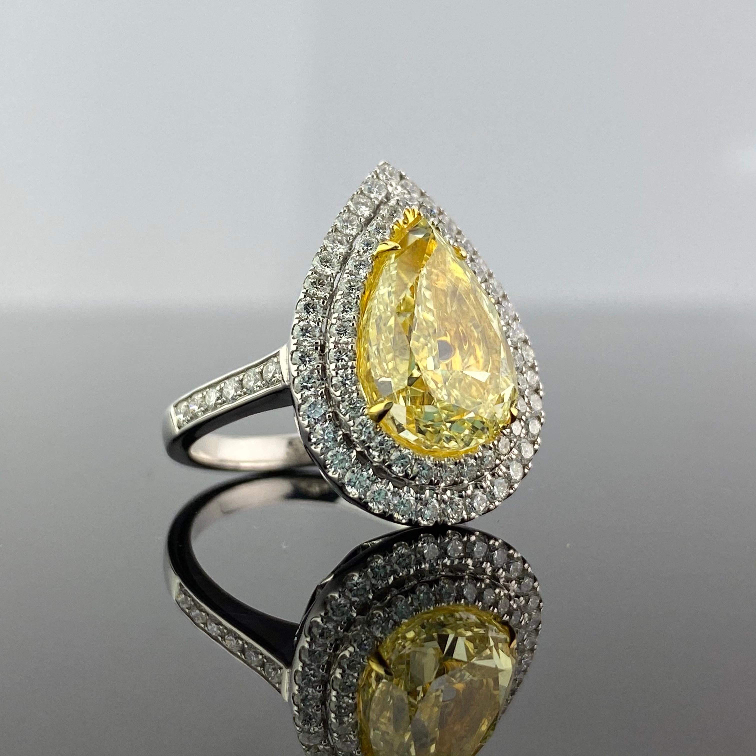 A stunning 5.02 carat, GIA certified Yellow Diamond Engagement Ring. The centre stone is of Y-Z colour, VS2 clarity. There are 0.92 carat of colorless White Diamonds, set in 7.57 grams of solid 18K White Gold. Currently size US 6.5, free resizing