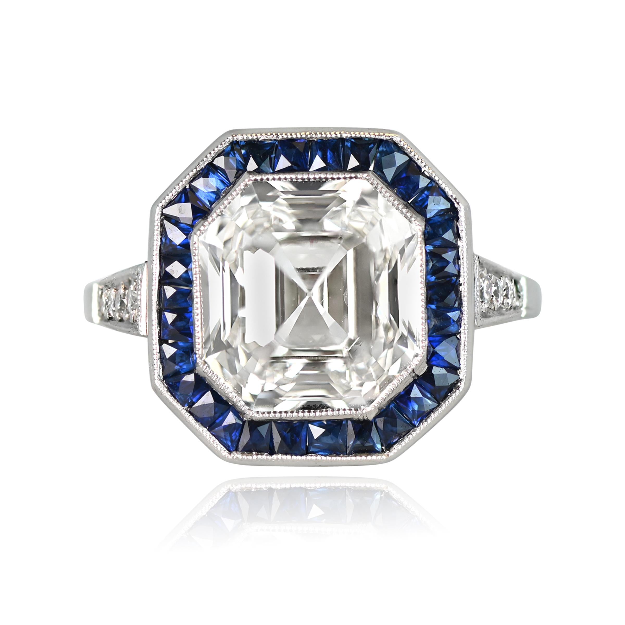 This captivating ring boasts an Asscher cut diamond, weighing 5.03 carats, with a K color and VS2 clarity certification from GIA. The center stone is surrounded by a stunning halo of French cut sapphires, while four old European cut diamonds are