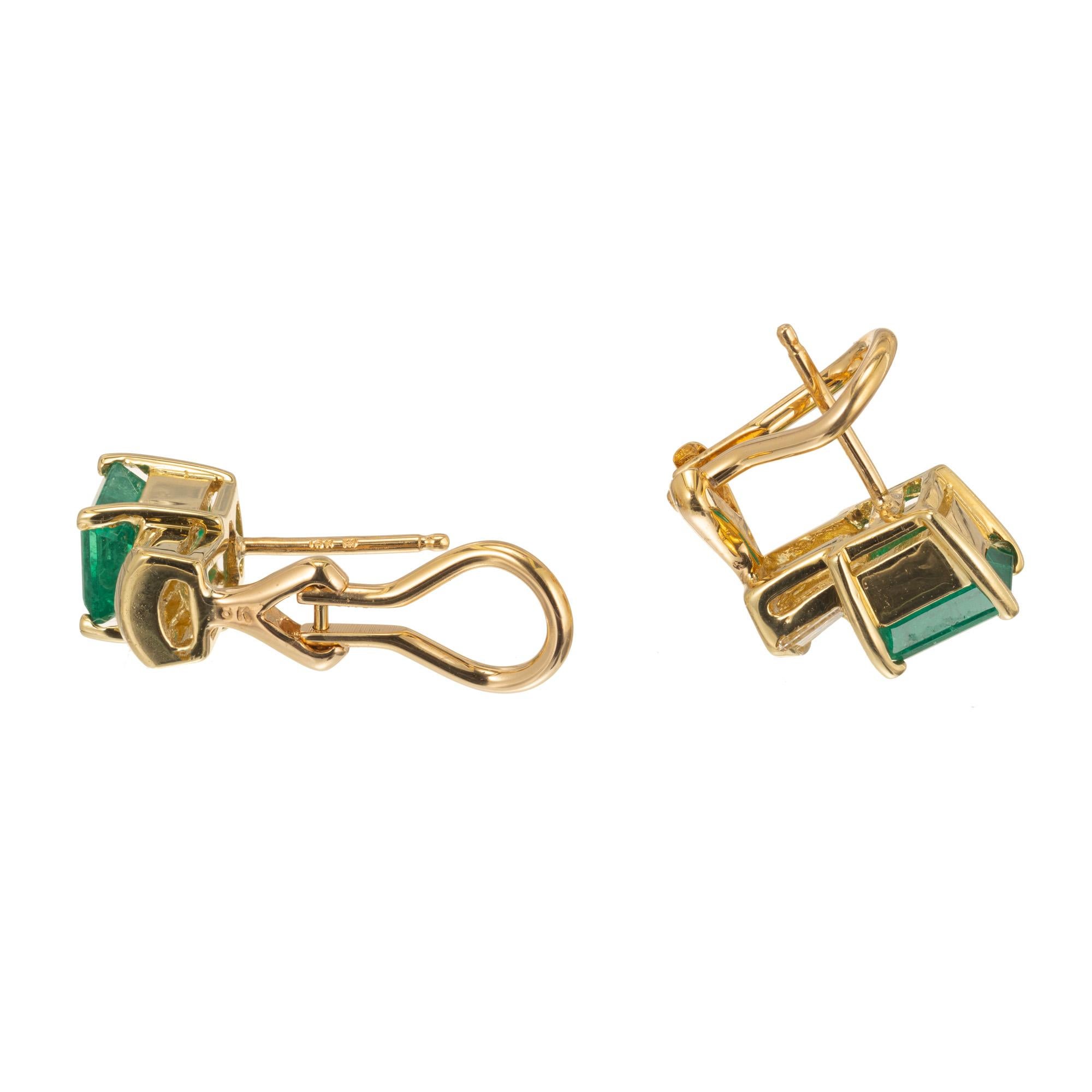 Green natural color Emerald and diamond clip post earrings in 18k yellow gold baskets with eight tapered baguette diamonds.  GIA certified natural color emeralds. GIA Certificate # 1162969629

2 bright green Emerald cut Emeralds, approx. total
