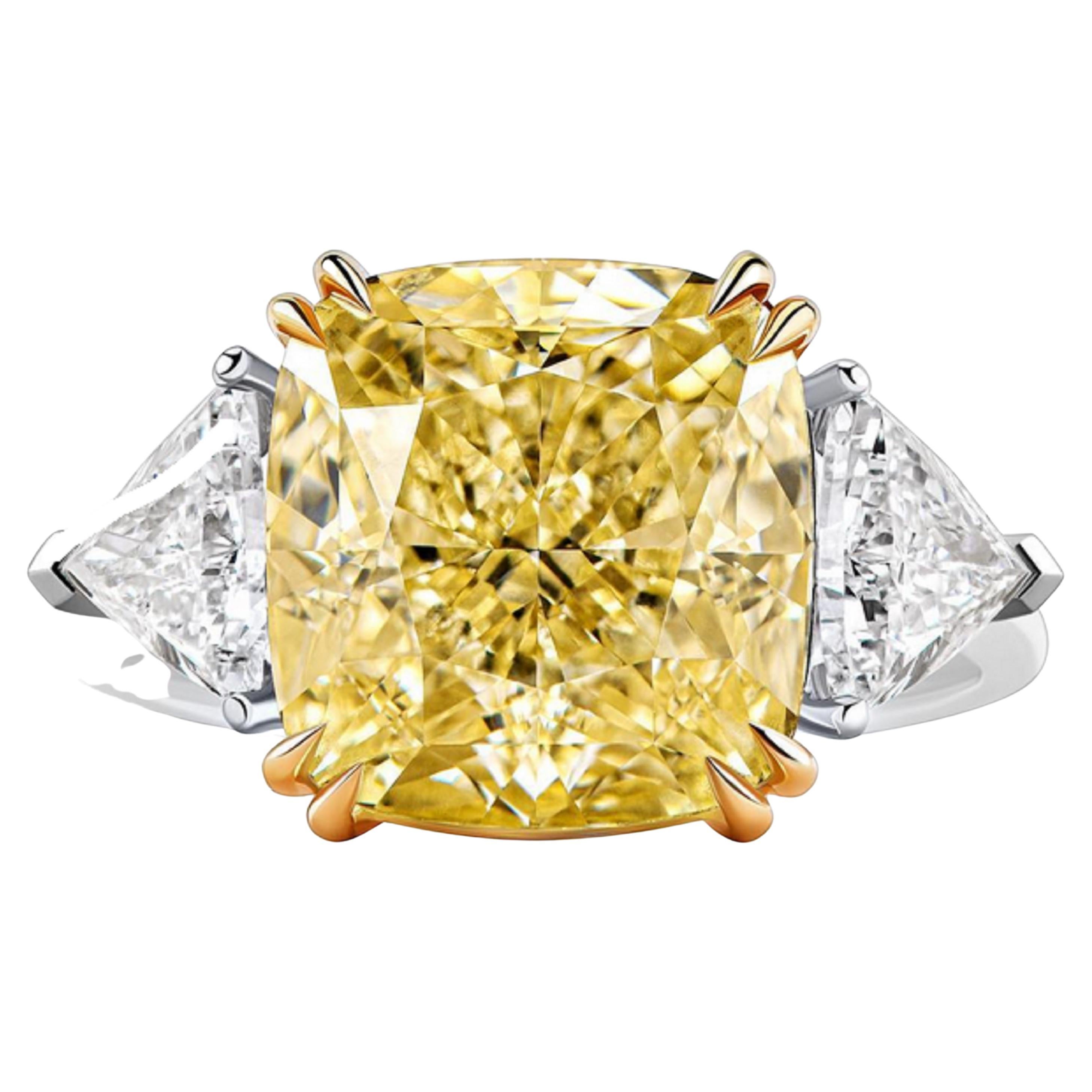 This exquisite ring features a GIA Certified 5.06 carat Fancy Yellow diamond, displaying a vibrant hue and graded VS1 for clarity. The diamond boasts Excellent Polish and Very Good symmetry, ensuring it sparkles with exceptional brilliance. Flanked