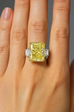 GIA Certified 5.02 Carat Radiant Cut Fancy Yellow Diamond Ring with trapezoid