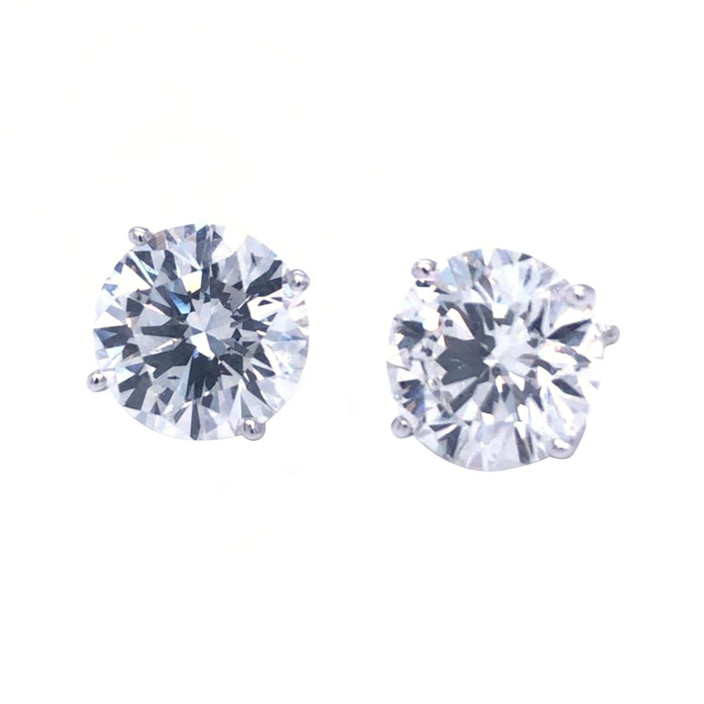 Stunning Diamonds solitaire stud earrings crafted by hand in 18K Gold, showcasing 2 spectacular GIA Certified round brilliant cut diamonds weighing 5.08 carats total,   H color Si1 clarity. These diamonds were carefully selected and perfectly