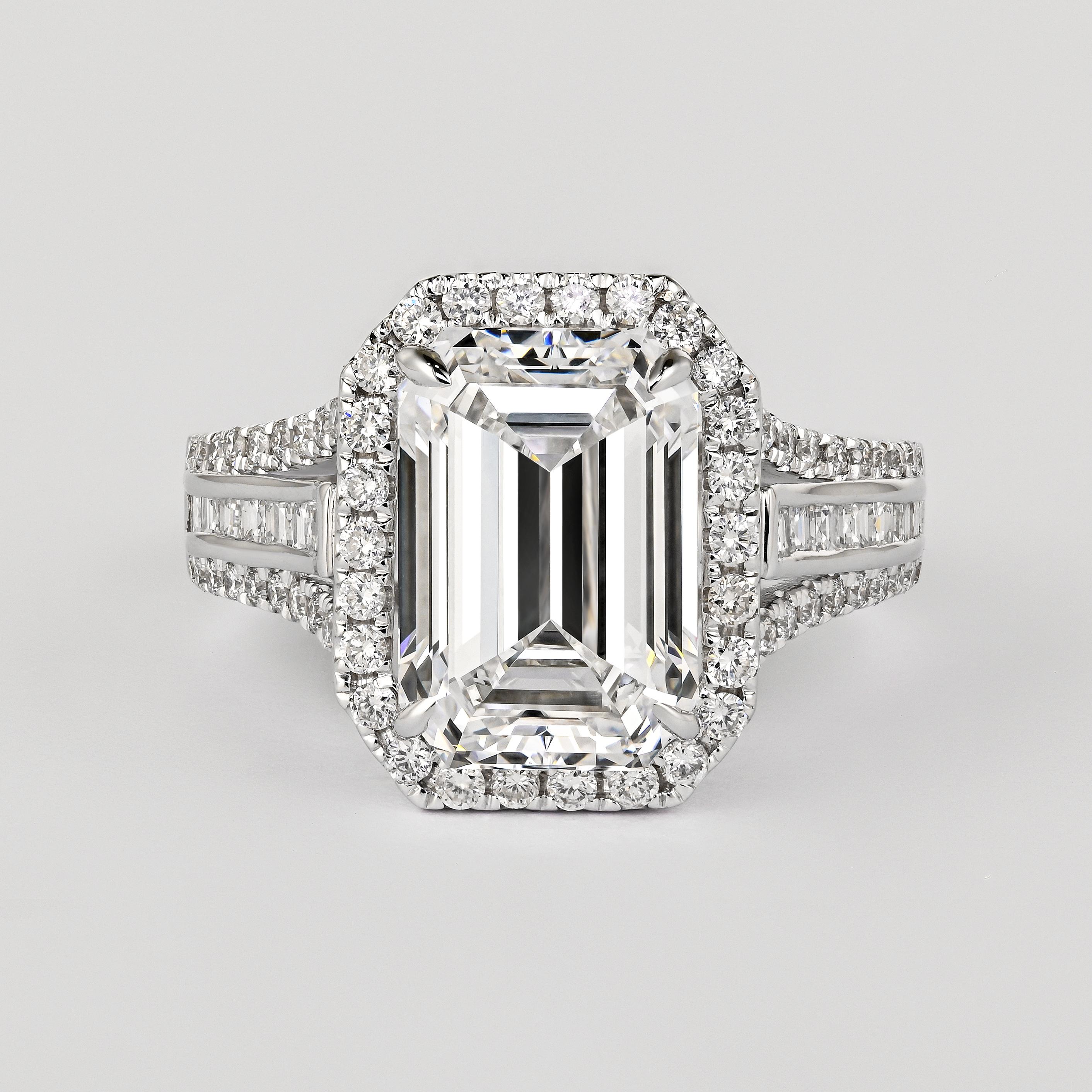 GIA Certified Natural 5.09 Carat Emerald Cut D/VVS2 Diamond and Round 0.90 CTTW Diamond Engagement Ring. The best color grade mother nature has to offer. A serious investment piece that transends most of the diamonds available today. 

Surrounded by
