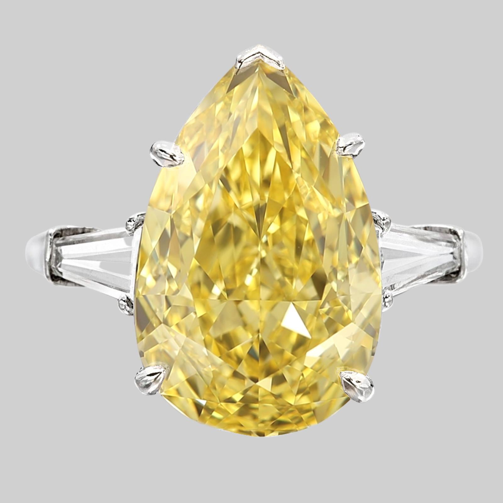 Magnificent emerald cut diamond ring  Speechless 5 Carats Fancy Yellow Pear Cut VVS in clarity. Certified by GIA set with 1 Carats of two impressive tapered diamonds set in Platinum and 18 carats Yellow Gold. 




