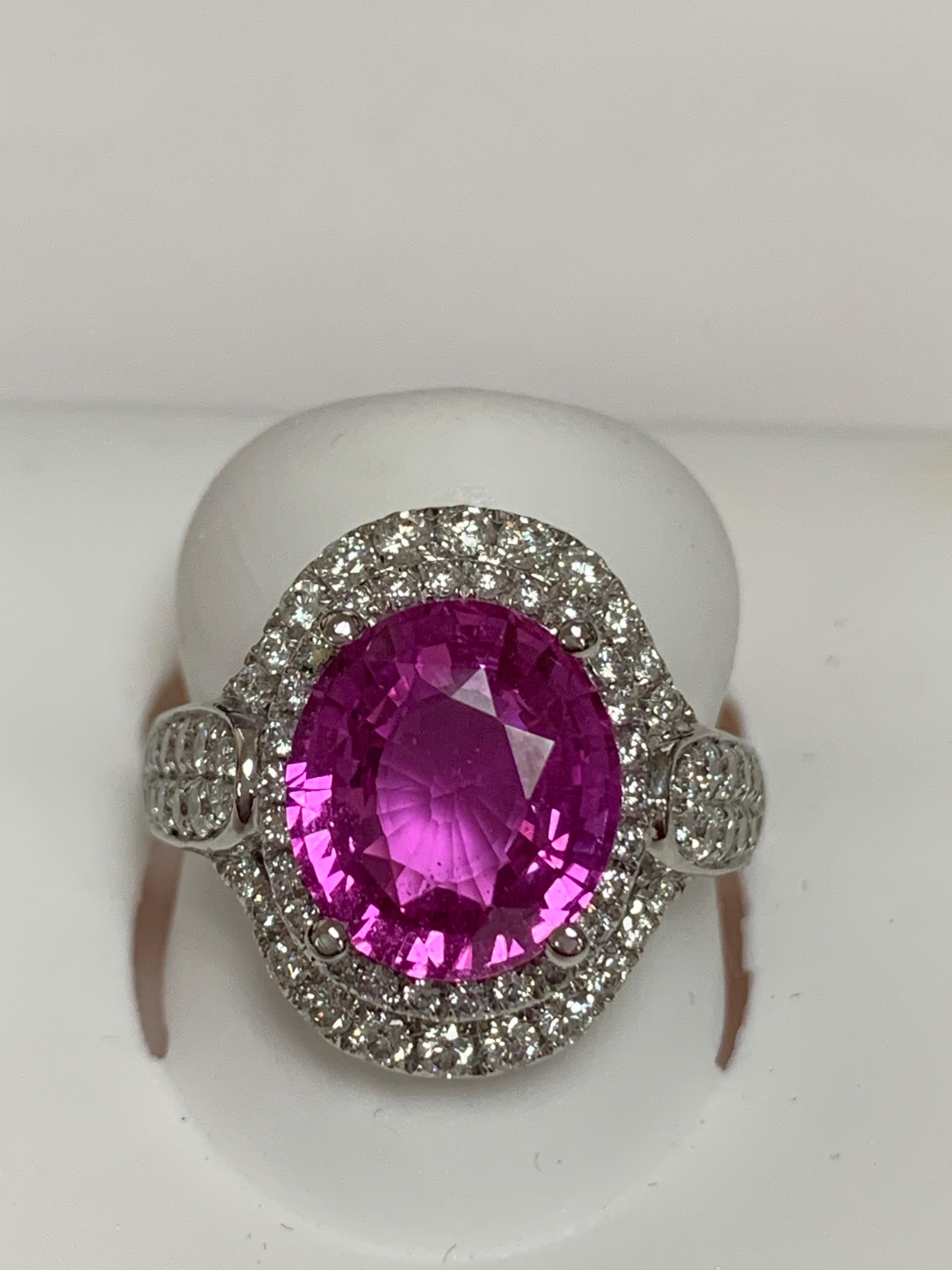 GIA Certified 5.12 Carat Pink Sapphire and 0.82 Carat round white diamond set in 14 Karat white gold, The Ring is hand crafted and one of a kind, The Ring can be resized if needed.