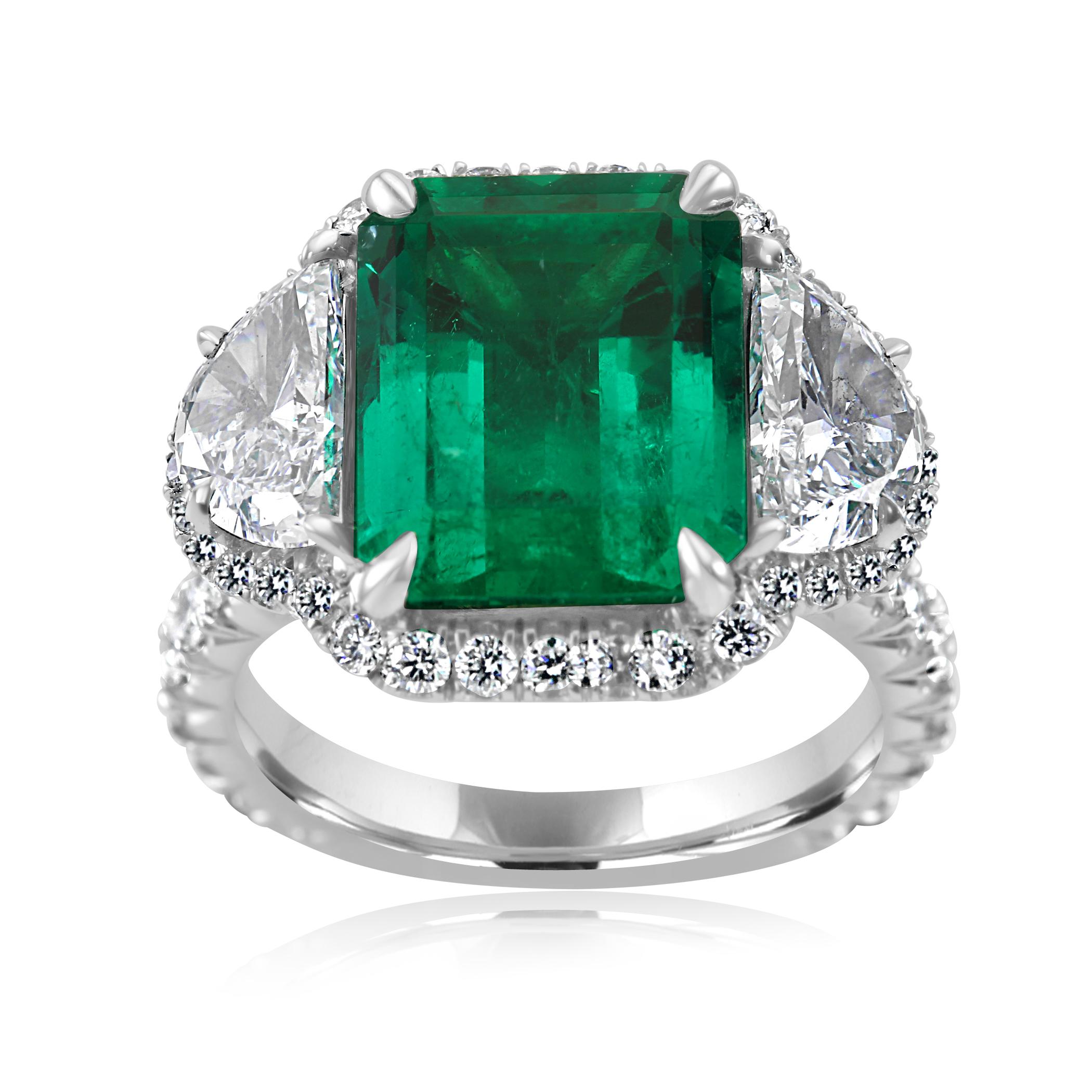 For The Collector, Extremely Rare and Exceptionally Gorgeous Quality 5.13 Carat No indications of clarity enhancement  Emerald Cut Emerald accompanied by a GIA Report. Flanked with 2 White G-H Color VS Clarity Diamond Half Moon 1.59 Carat encircled