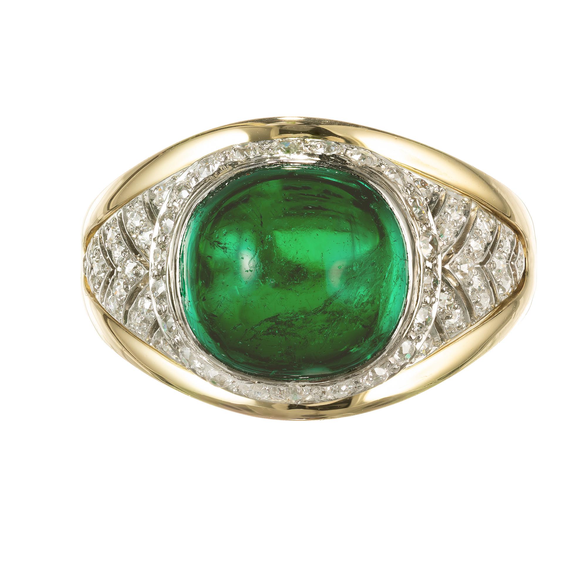 Handmade Colombian vivid green Emerald and diamond ring. Cabochon GIA certified center stone with 52 round old european cut diamonds. Natural minor surface abrasions. Handmade 18k yellow gold and platinum setting. 

1 vivid green cushion cabochon