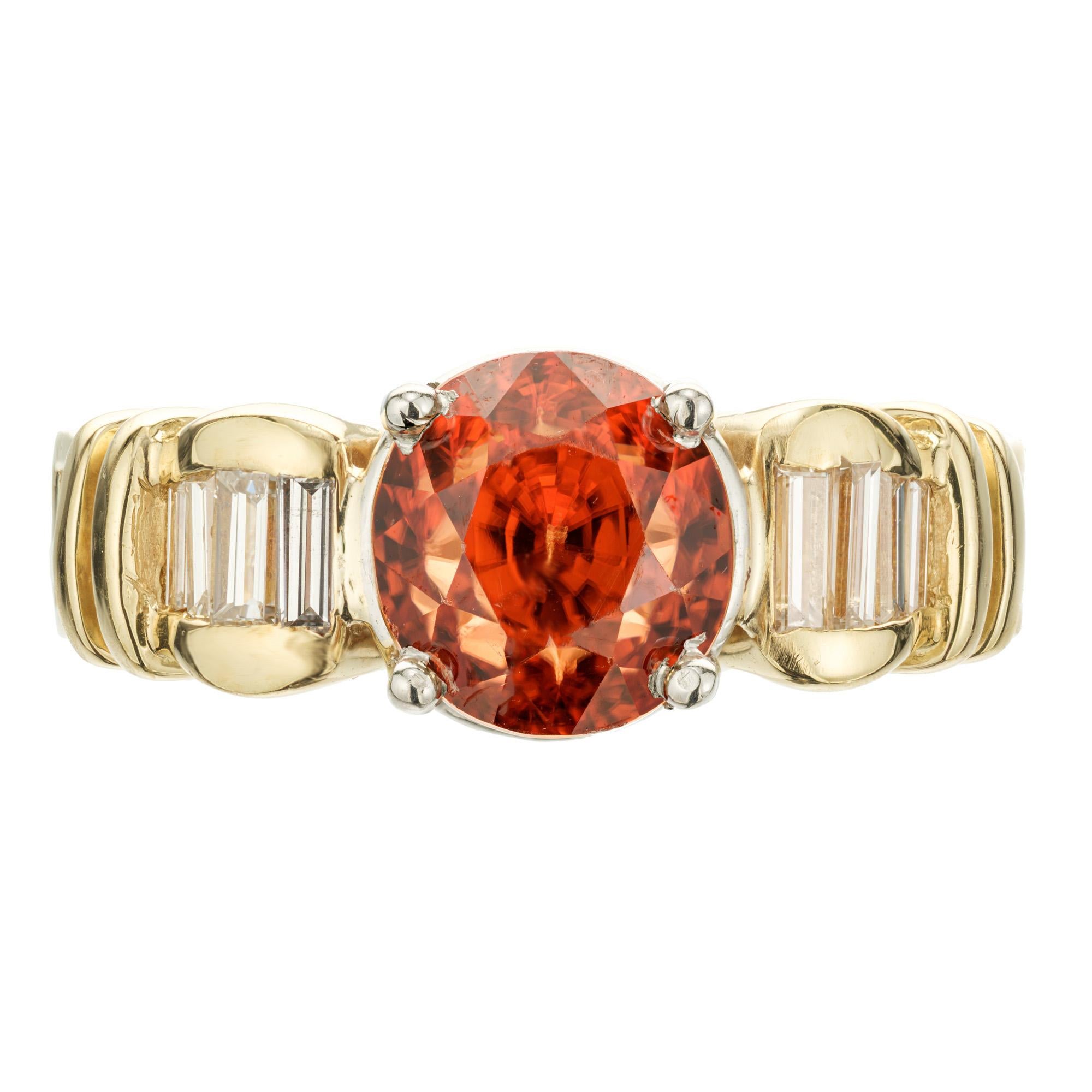 Zircon and diamond engagement ring. GIA certified 5.16ct orange cushion cut Zircon set in 18k yellow gold setting with a platinum crown. 14 baguette cut accent diamonds. GIA certified natural untreated Zircon.

1 cushion orange Zircon, approx. total