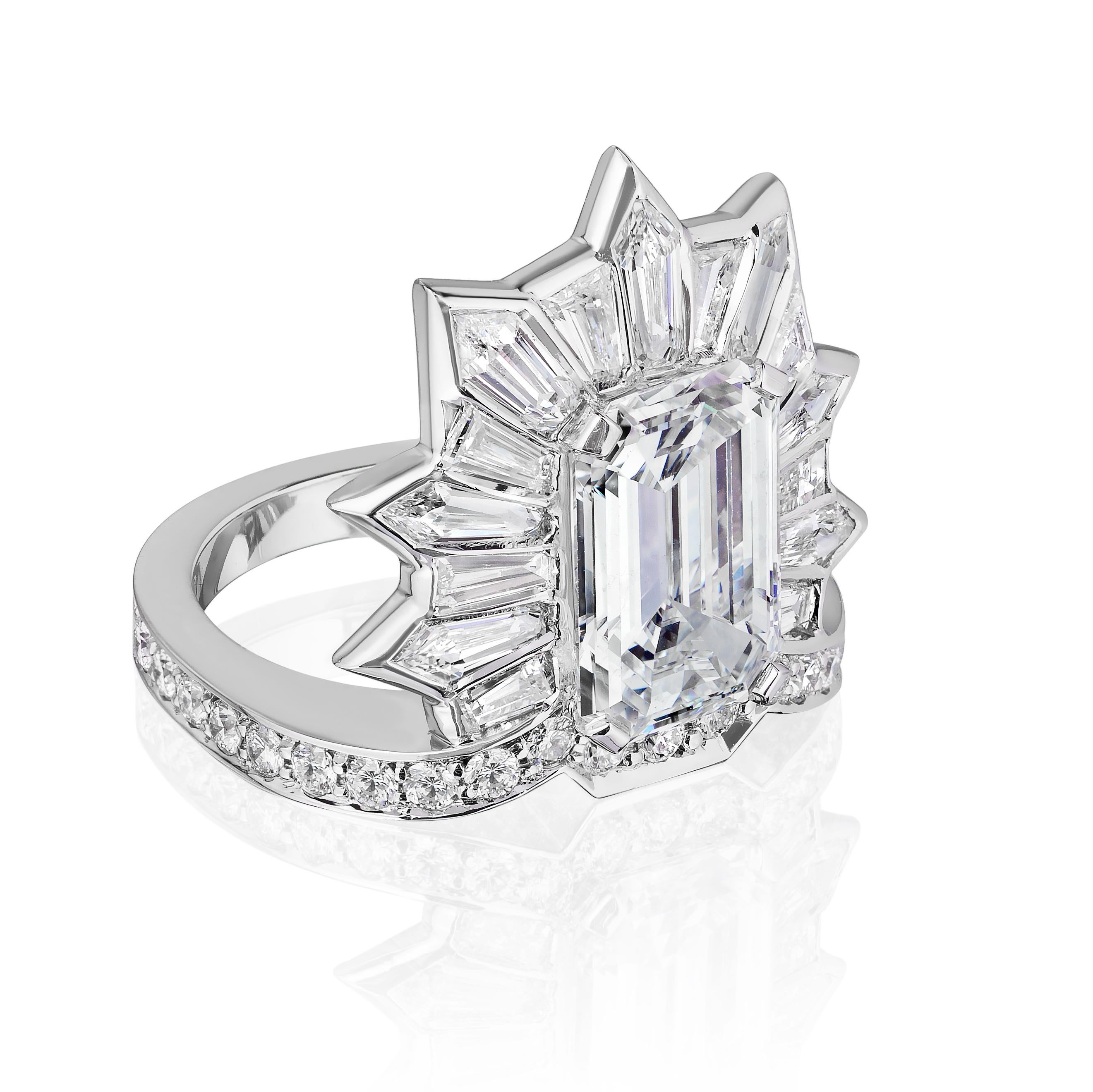 Highly unusual Emerald Cut Diamond Cocktail Ring.

Emerald Cut center stone weighing 5.20 Carats surrounded by Kite and Baguette shaped Diamonds weighing 2.25 Carats with Round Brilliant Diamonds weighing 0.60 Carats.
Emerald cut is GIA certified as