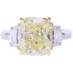 GIA Certified 5.20 Carat Fancy Yellow SI1 Cushion Diamond Three-Stone Ring