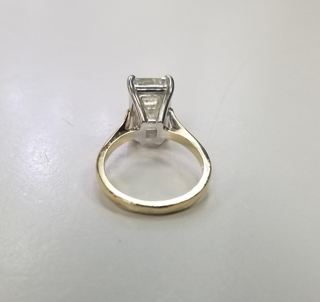 Contemporary GIA Certified 5.02cts. Emerald Cut Classic Diamond set in 14k gold 